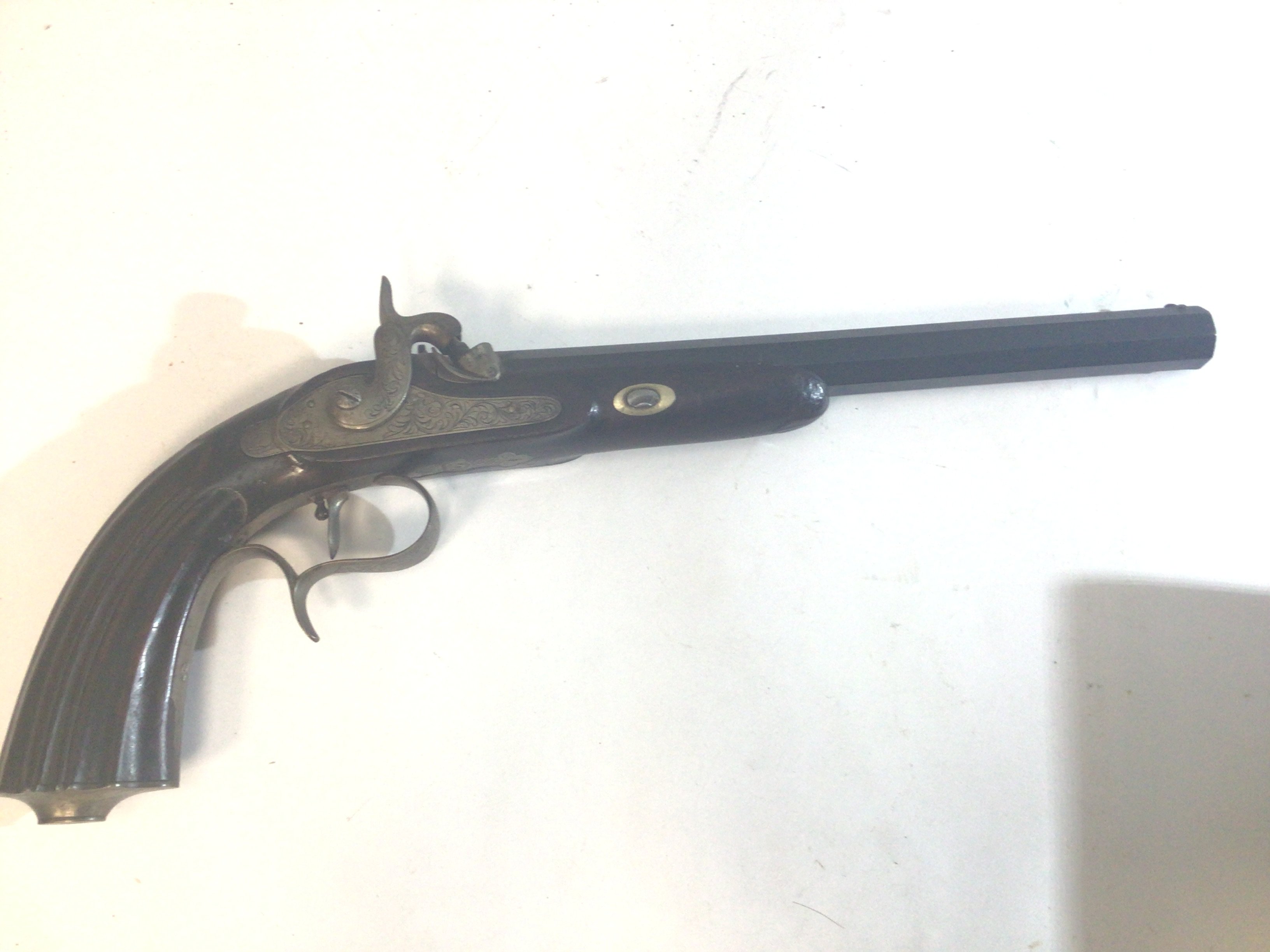 A 19th Century French Percussion Target Pistol or dulling pistol with walnut carved grip with an octagonal Damascus barrel. Engraved steel action Le Fever. The action works.