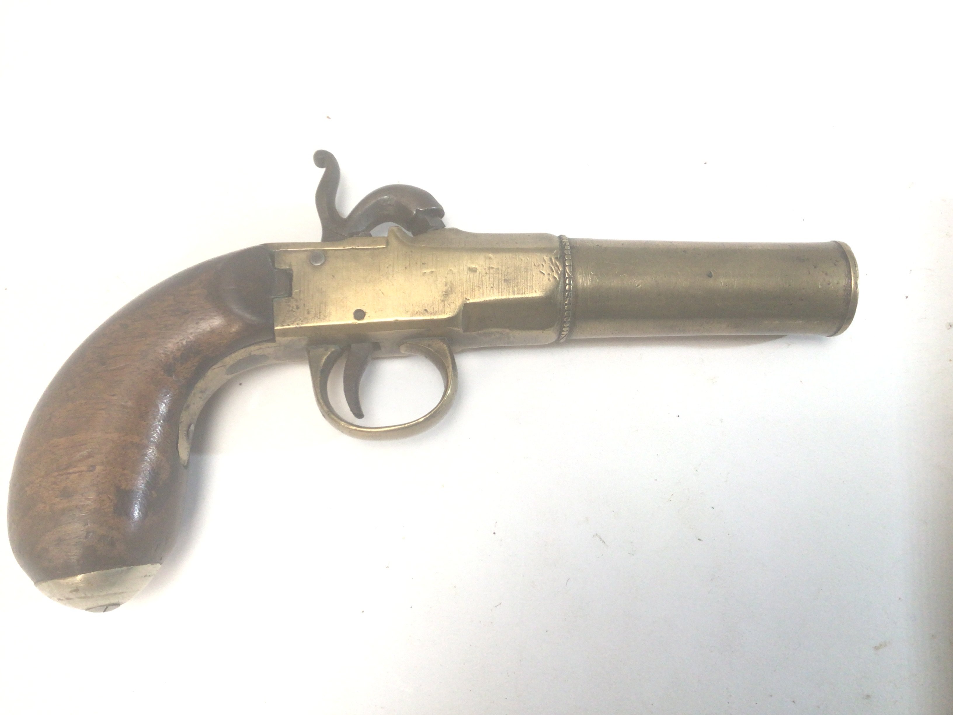 A 19th Century brass canon barrel Percussion pistol with central positioned hammer.