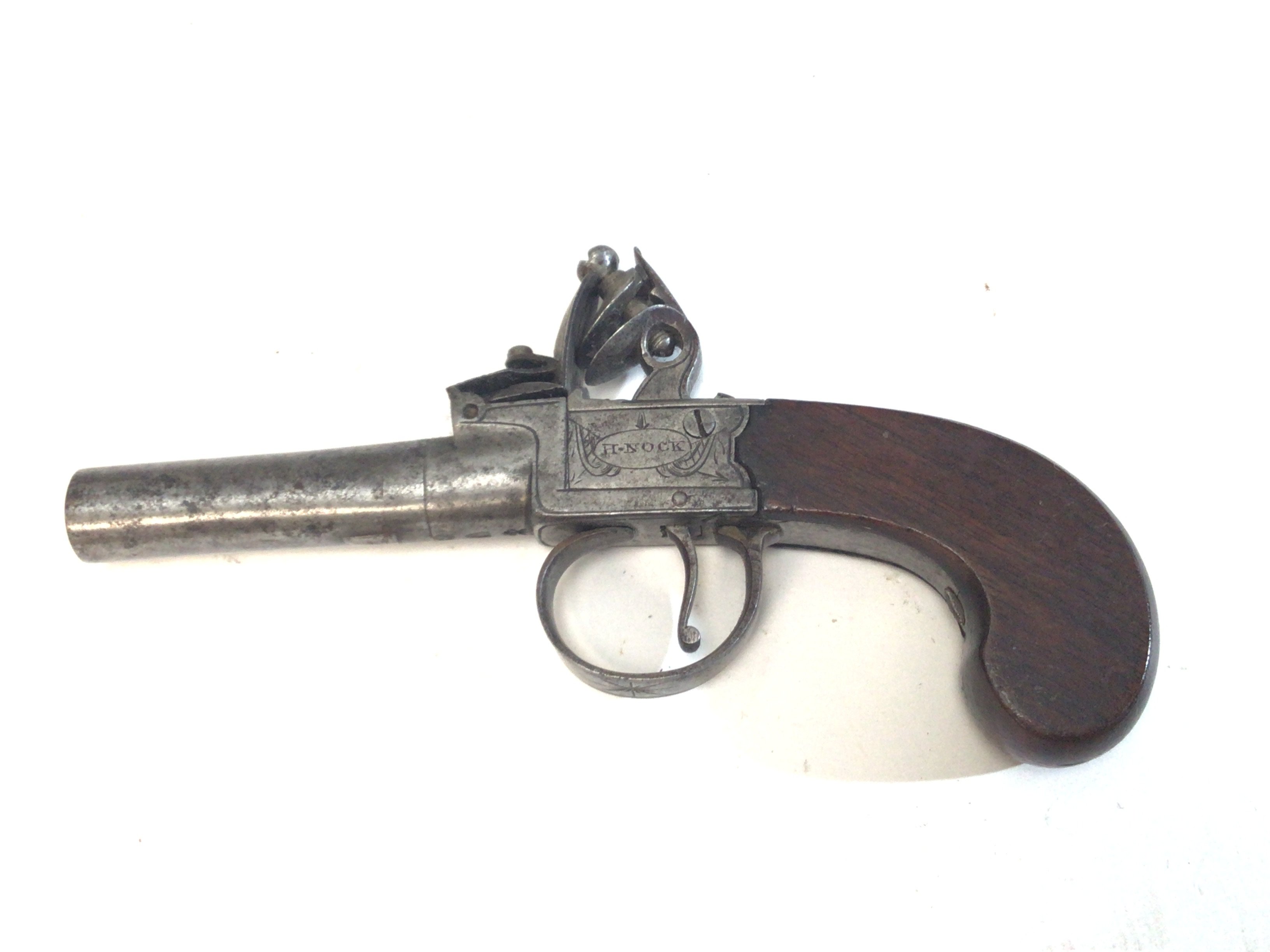 An 18th century flintlock lock pocket pistol with a steel twist off barrel and slab sided action maker H Nock the barrel with proof marks length 17cm