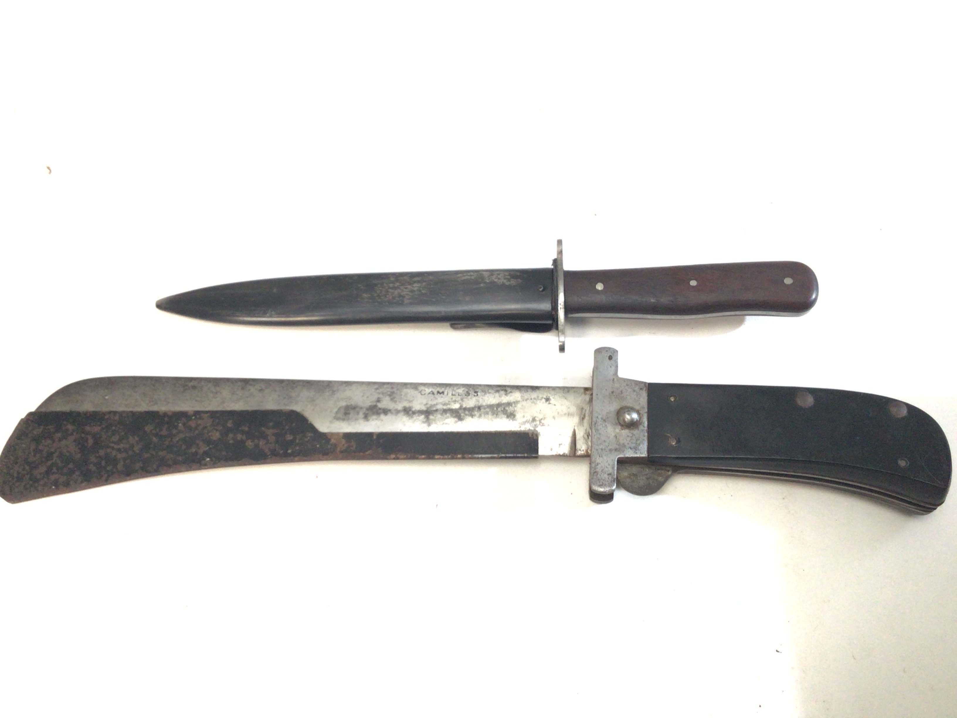 An unusual Camillos folding Machete with blade edge cover length 40cm and a Military fighting knife with steel scabbed and wood grip unmarked (2)