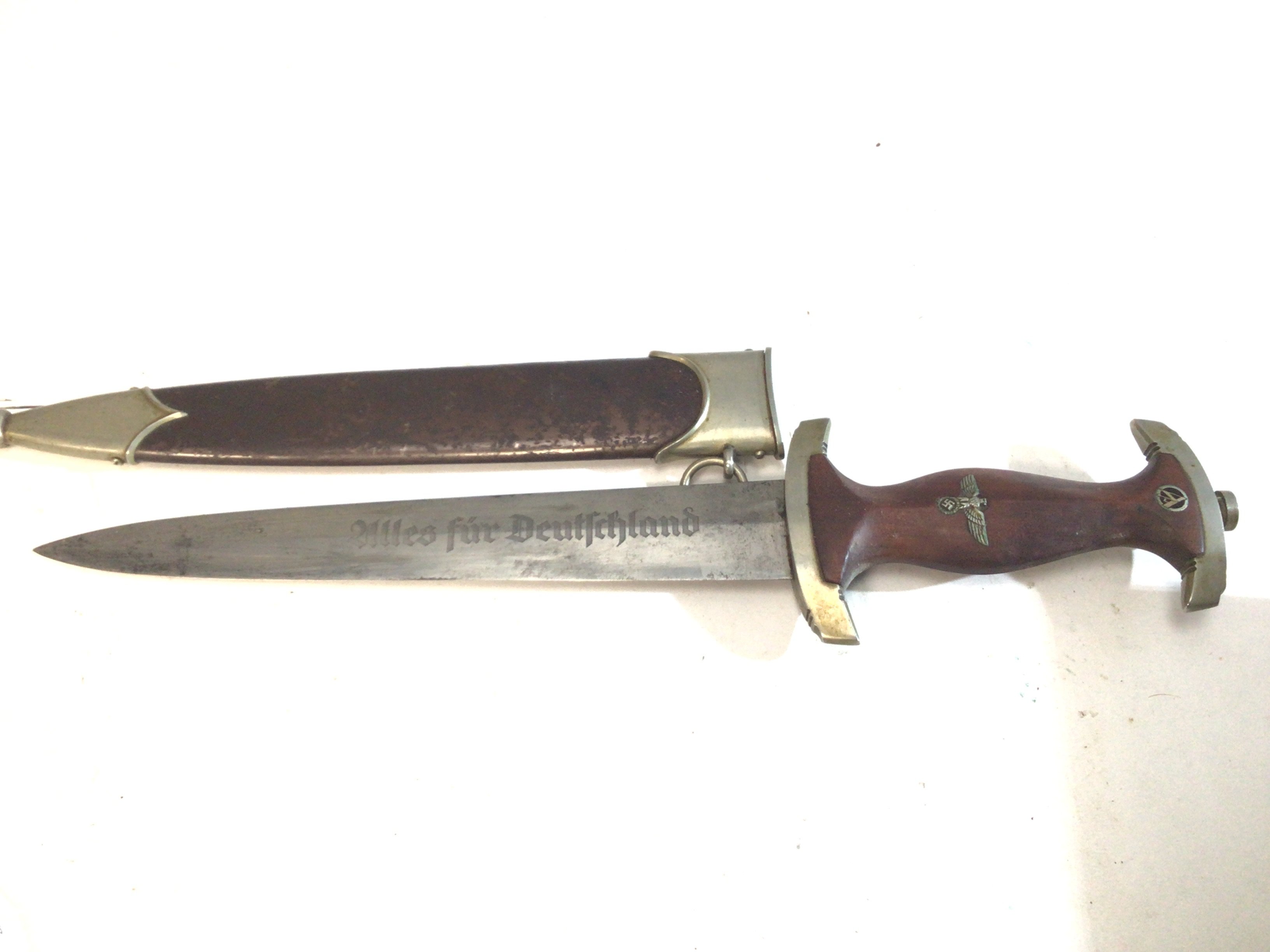 An Early Example German SA dagger 1935 or slightly later issued to the Brown Shirts. The blade with inscription and maker Hugo Rader brown finish. No on the cross guard.