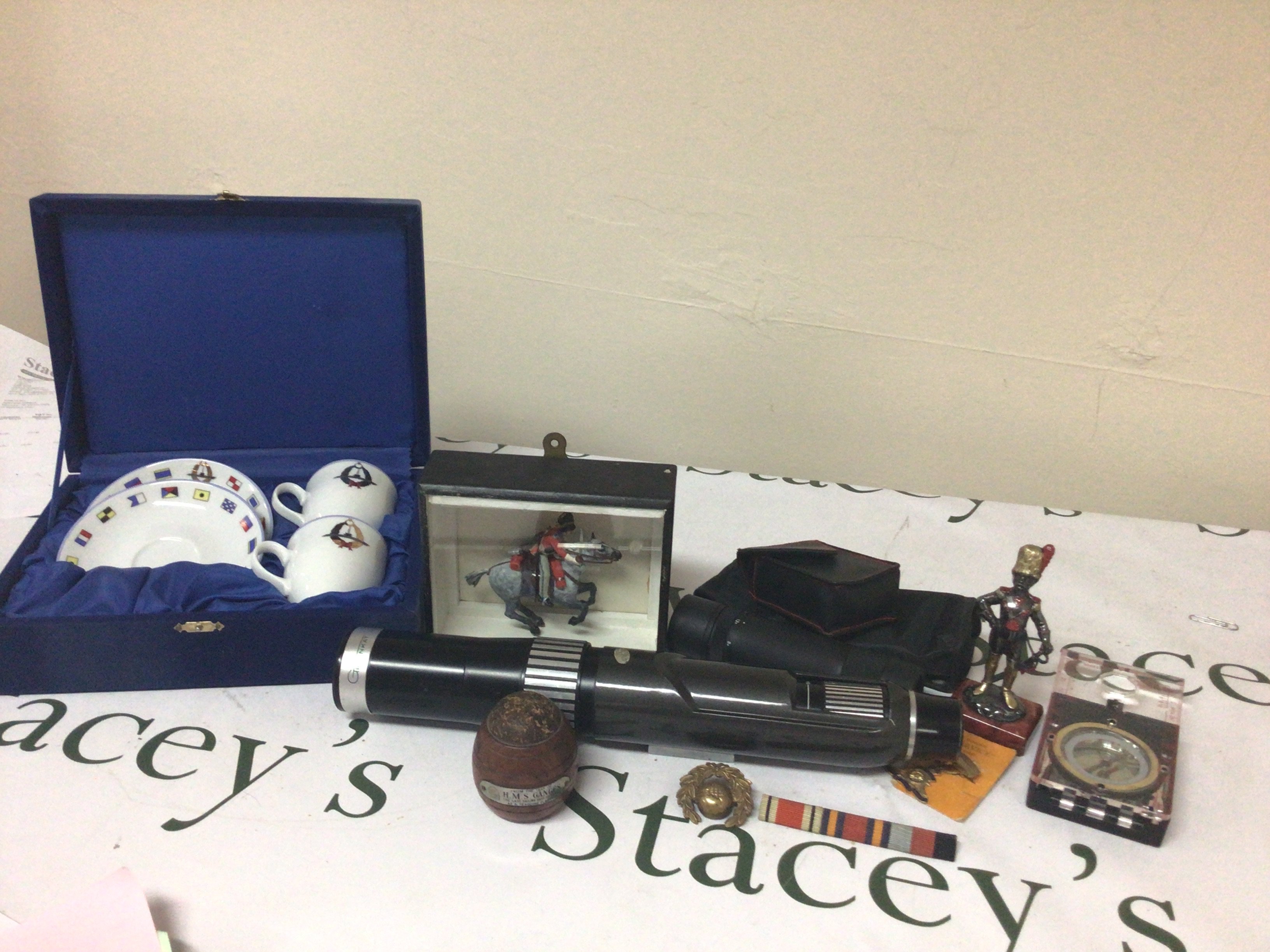 A Collection of Military oddments. badges soldiers a wood sample from HMS Ganges. The last flagship.