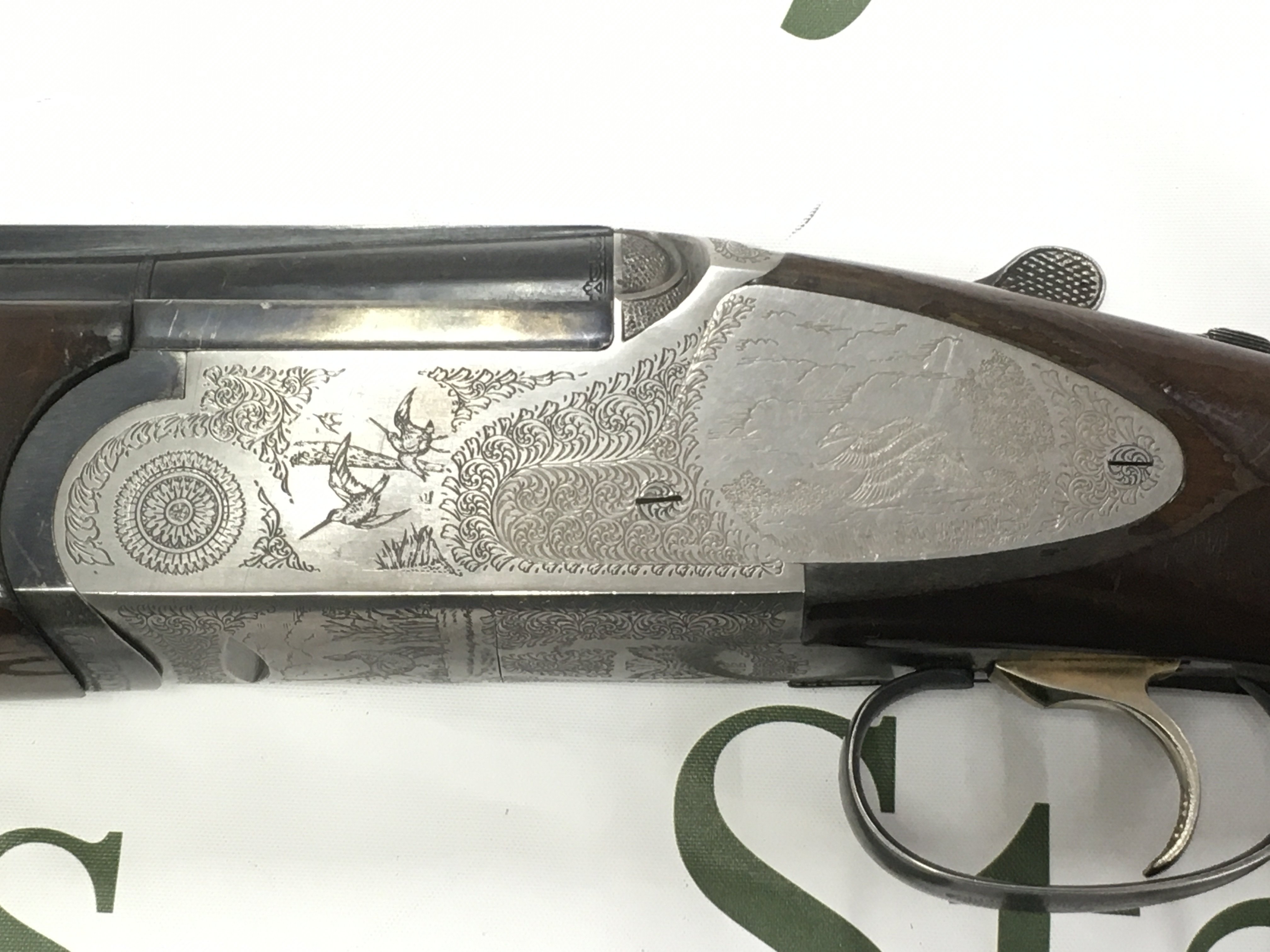 A Rizzini E 12 gauge side plate over under shotgun. Multi choke single trigger. 28inch barrel. Serial number 69967. PLEASE NOTE THAT A SHOTGUN LICENSE IS REQUIRED TO PURCHASE THIS ITEM. COLLECTION AND VIEWING BY APPOINTMENT ONLY.