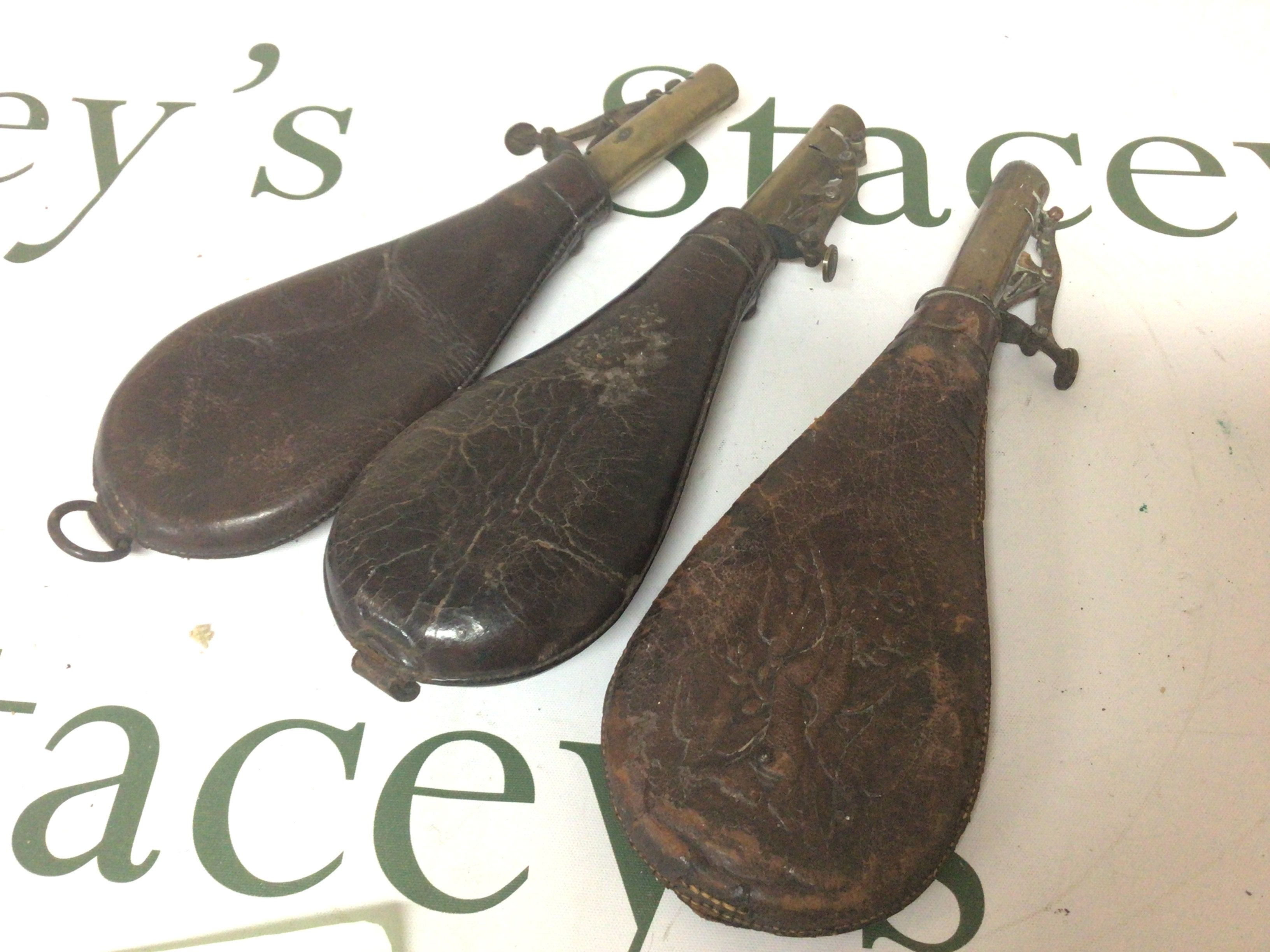 Three 19th century powder flasks with brass tops (3)