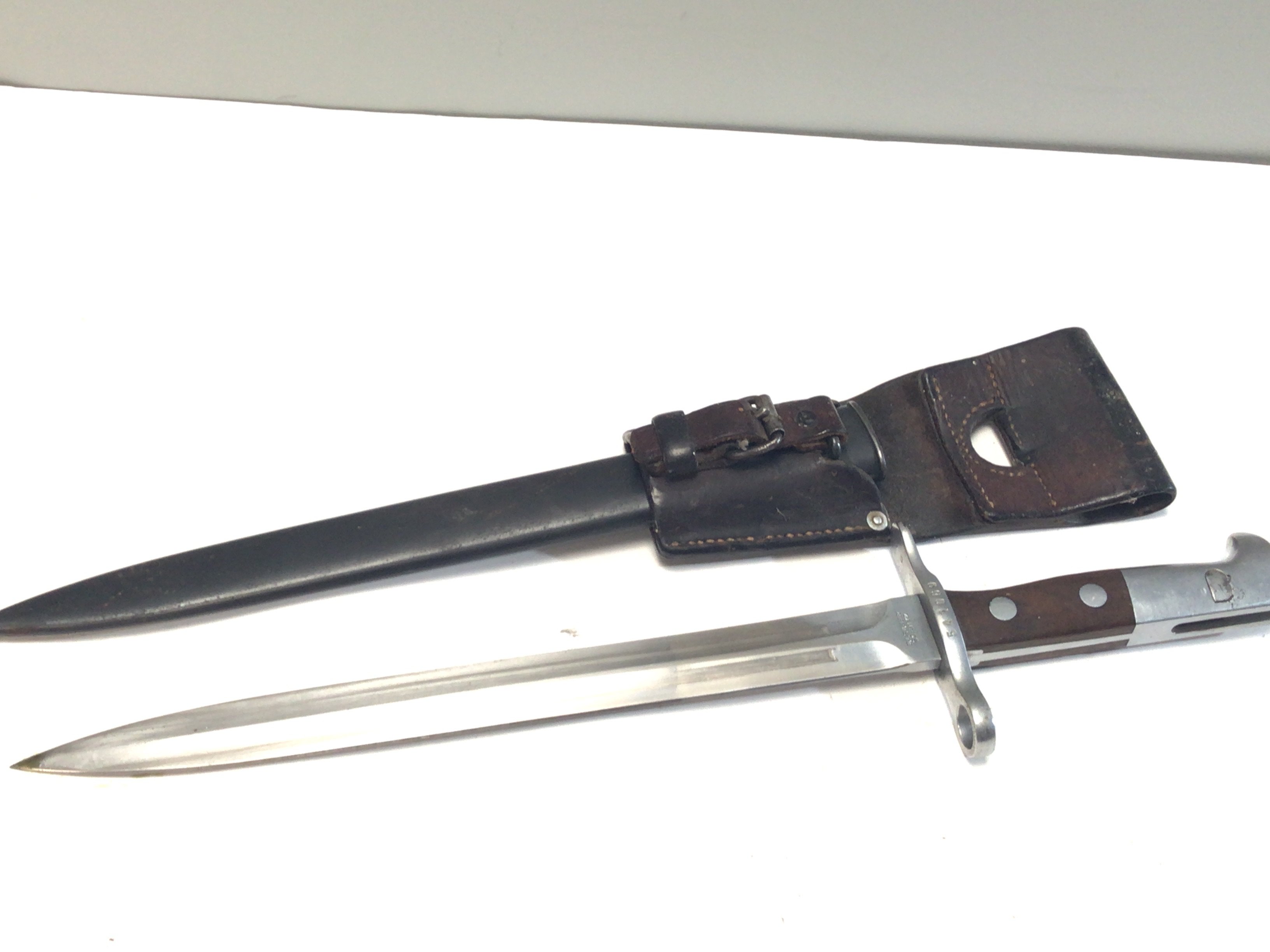 A Swiss Bayonet good example with a wood grip leather belt attachment maker Elsener Schwyz serial number 541069.
