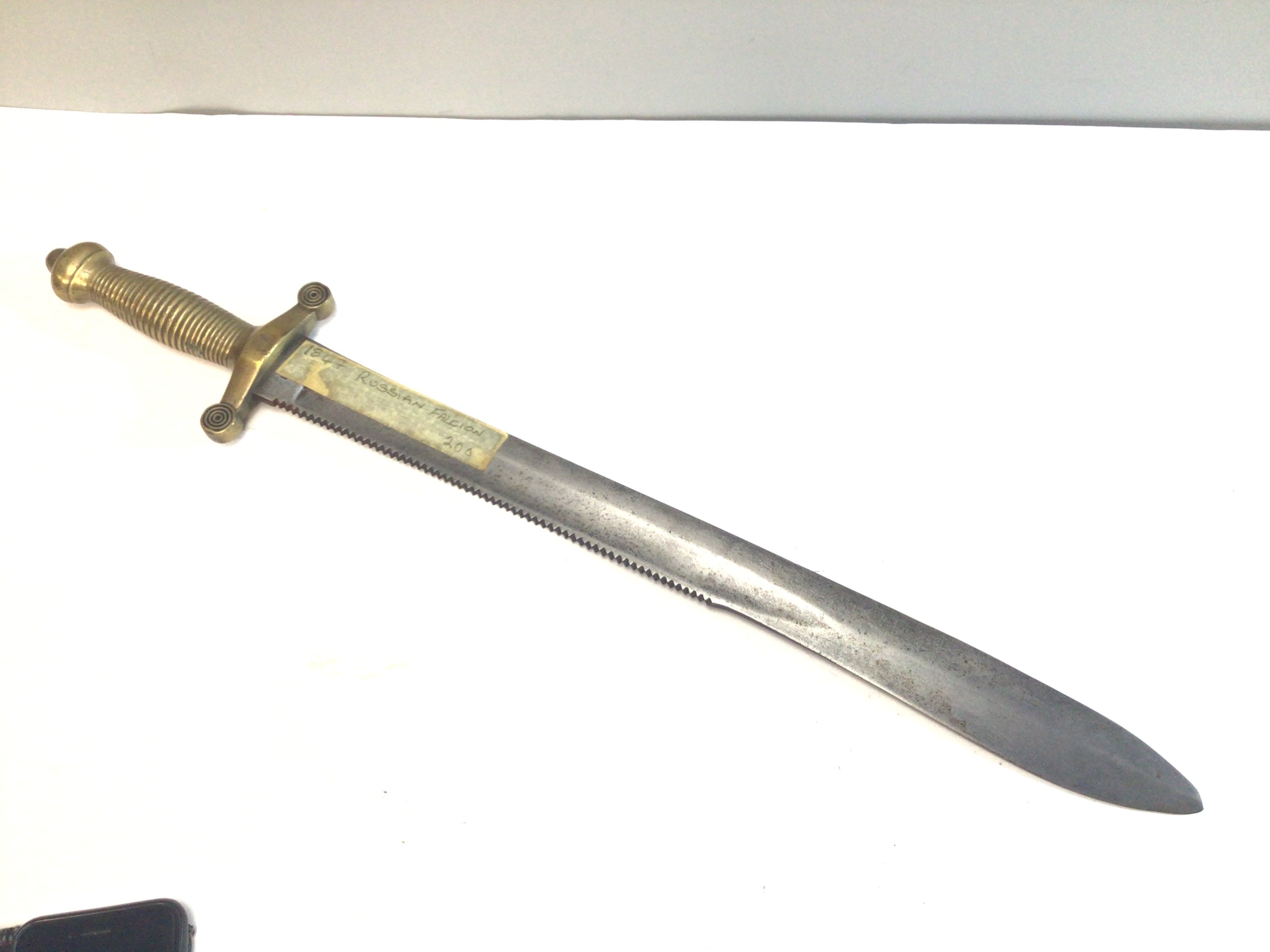 A Russian Crimean War Pioneers Tesak Model 1847 short sword with a sawback edge brass grip of Roman inspiration. No scabbard.