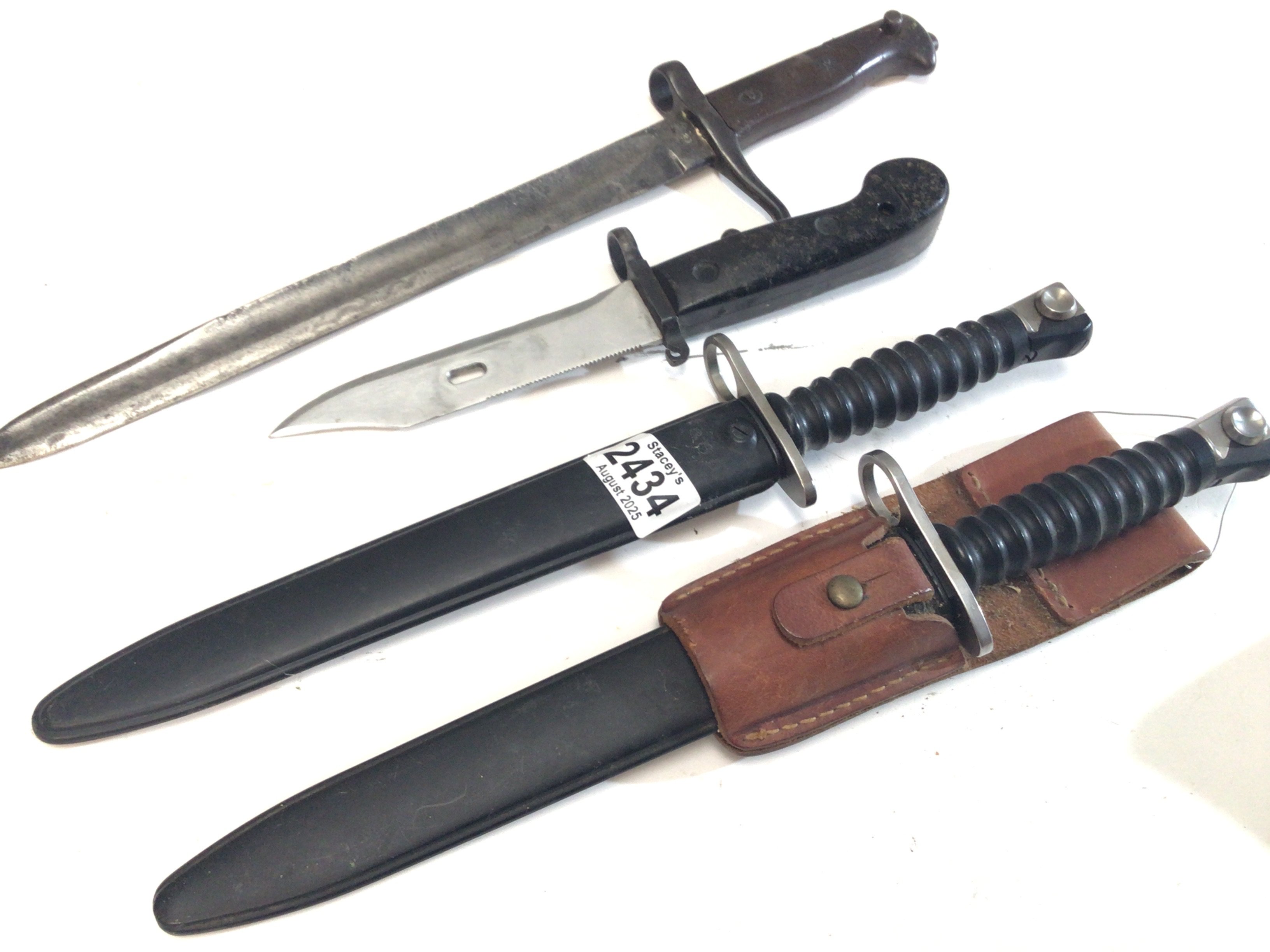 Two Swiss 1957 pattern bayonets one with a leather frog and Russian Klashnekoff bayonet and one other bayonet (4)