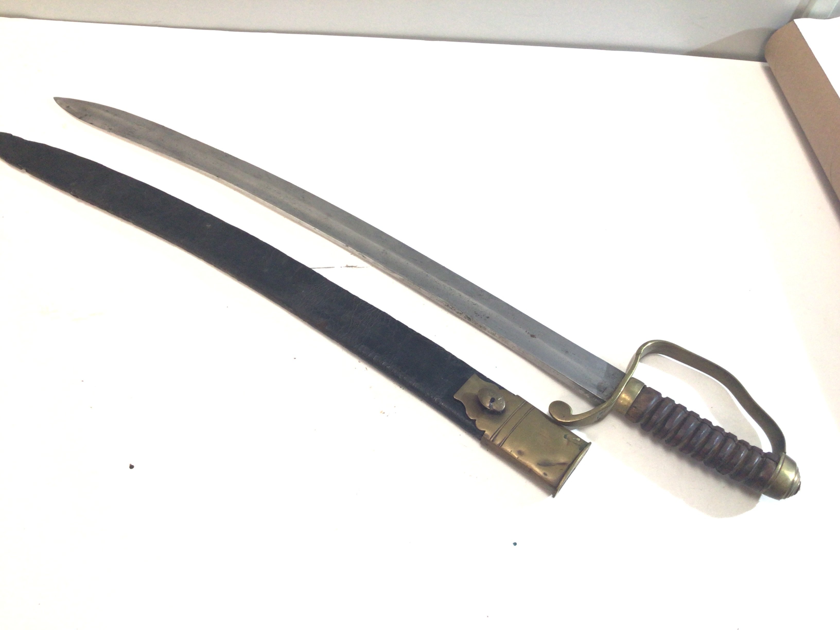 A Victorian Police officer sword with a wood grip brass cross guard numberer 273