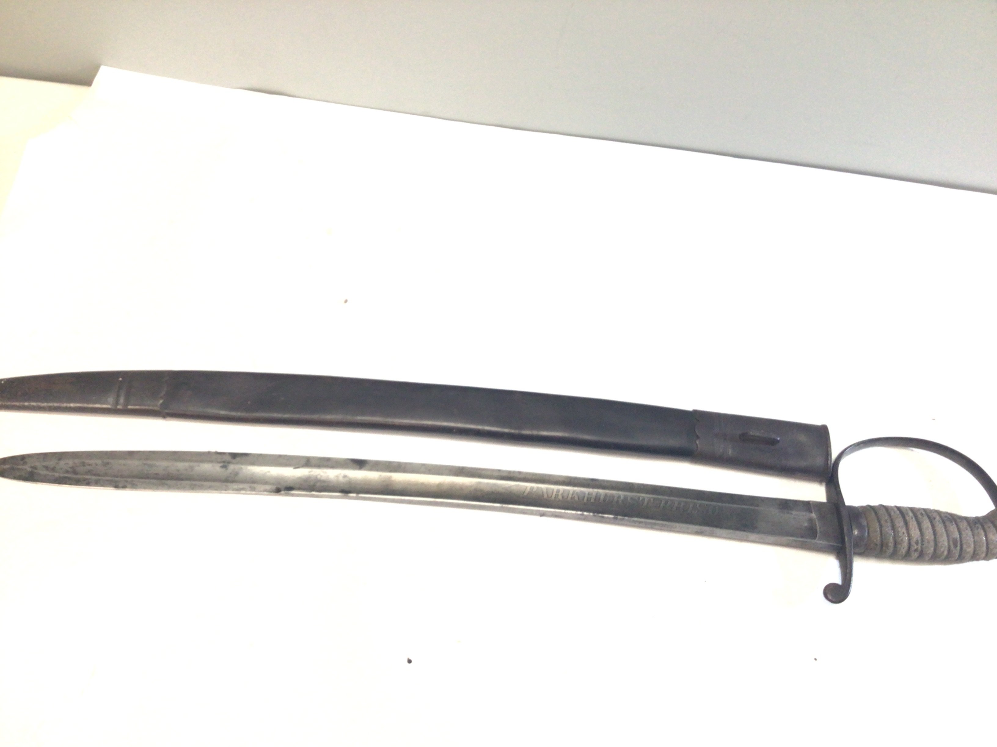 A rare Victorian Prison officers Sword Parkhurst Prison the sword with a wired shagreen grip the steel blade with maker P Parker & Son 233 Holborn.the leather scabbard needs stitching