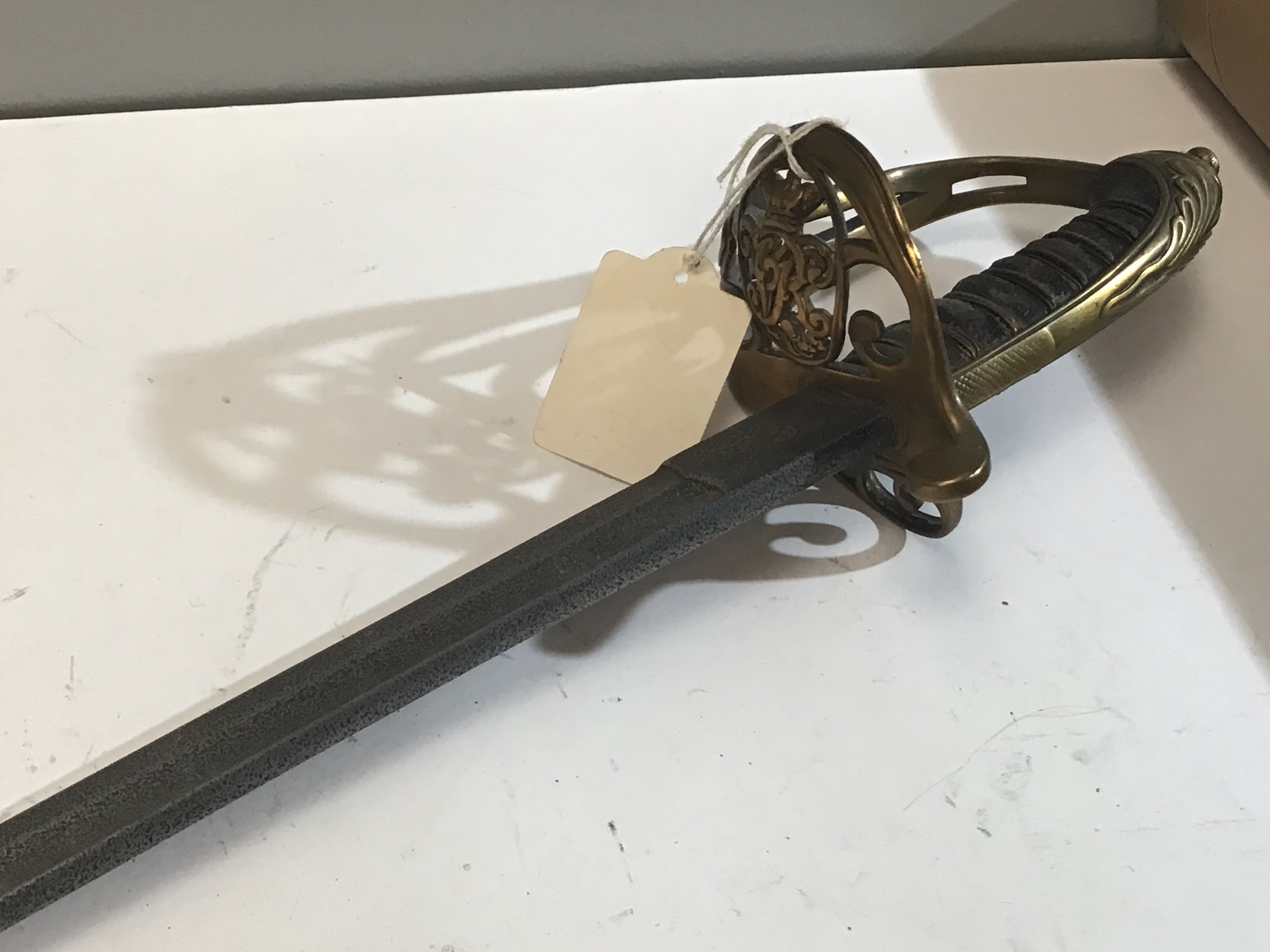 A Victorian British Navy officers sword the brass hinged Guard with Victorian Royal Cypher steel blade with small inset possible makers mark no scabbard.