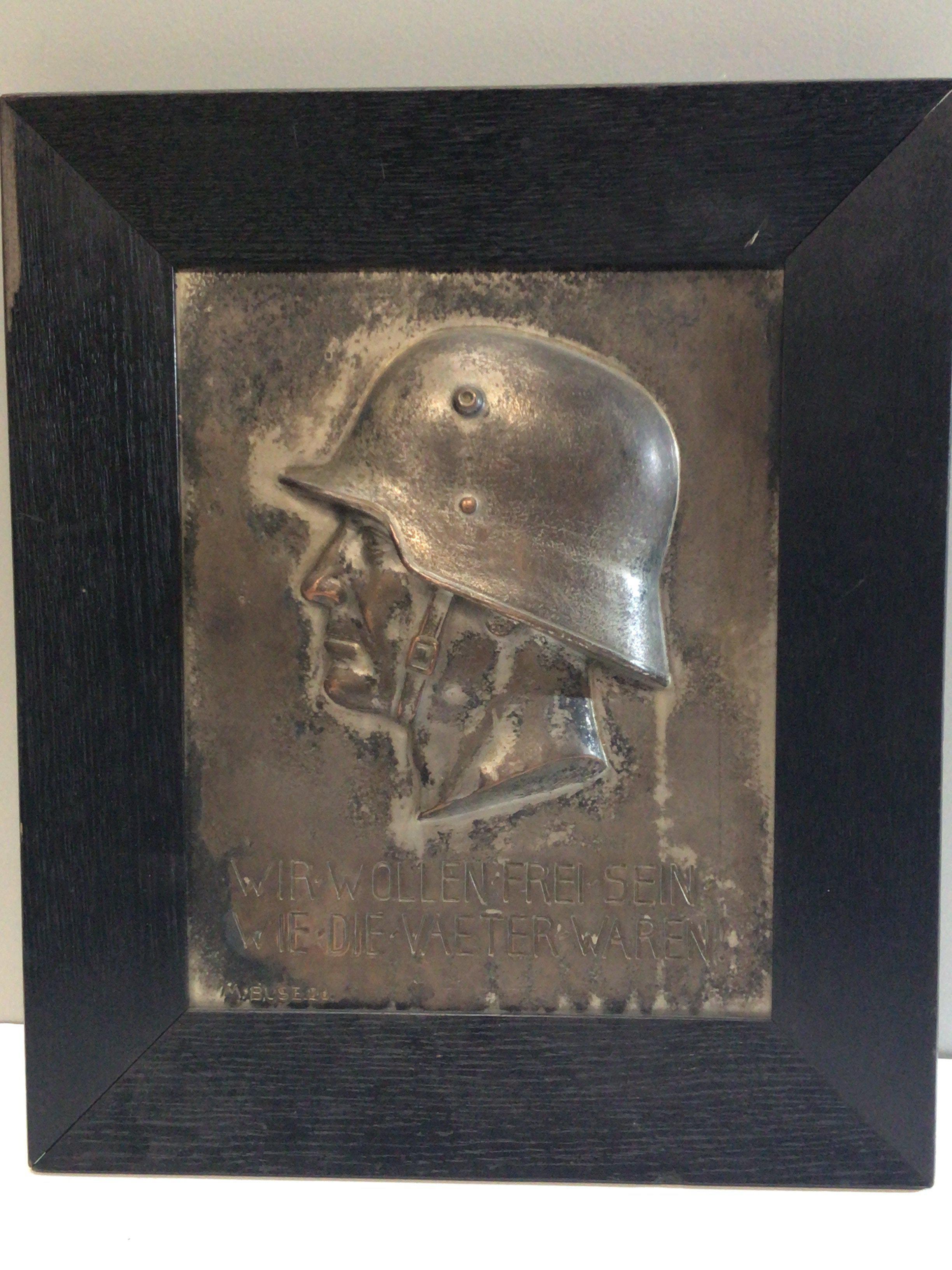 A German Third Reich Honour Plaque with a side profile of a Soldier with the German inscription We Want to be free as the Father were. 37x43cm