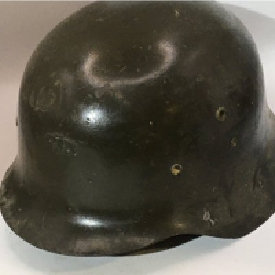 A German Third Reich M42 pattern helmet green with attached bracket above the peak thick cut leather liner. No obvious stamp marks.