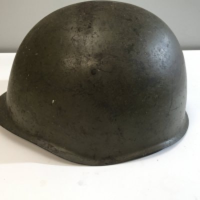 A Green combat helmet possible American II world war unmarked with leather liner.