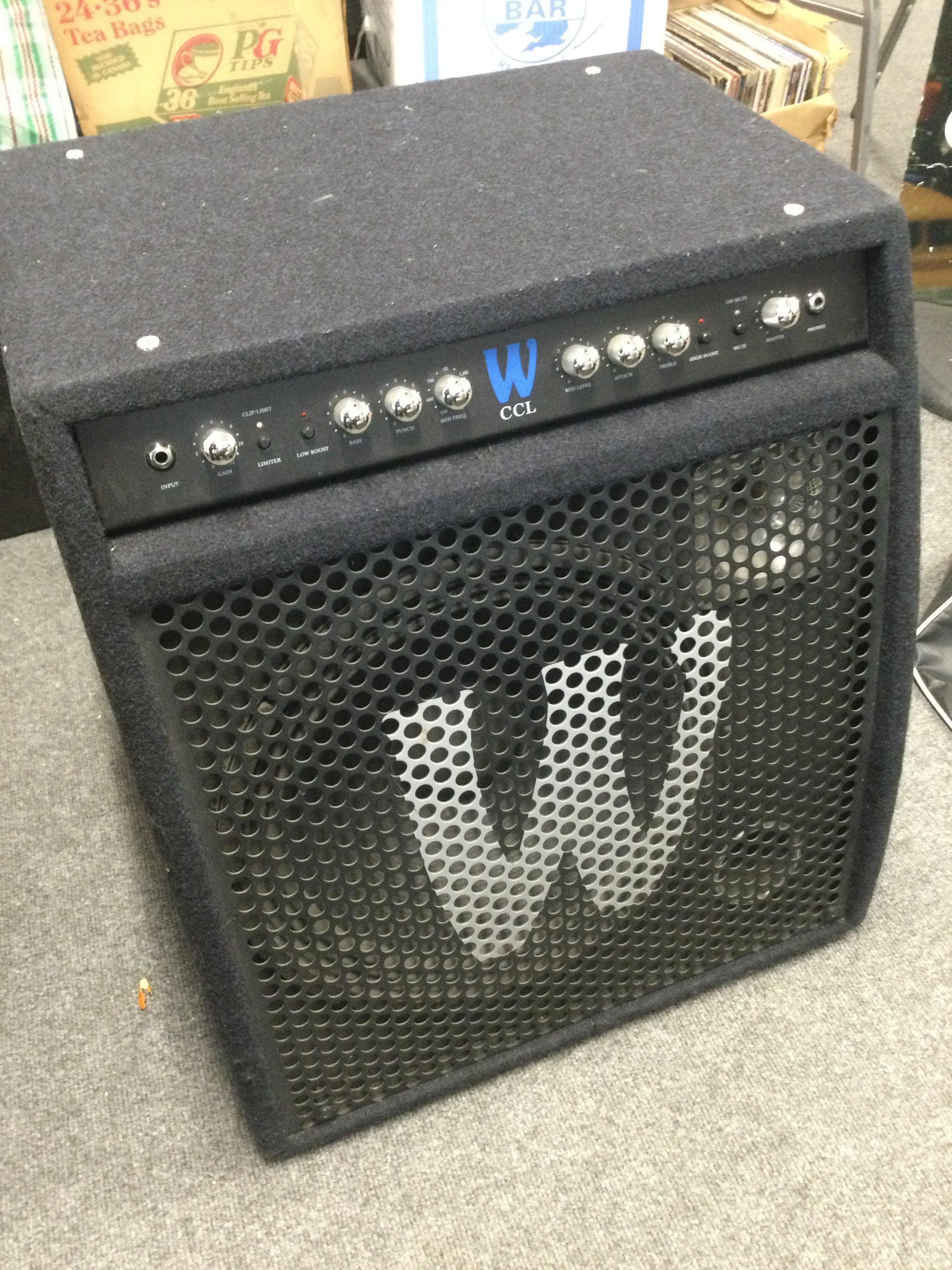 A Warwick CCL 250W 1x15" bass guitar combo amplifier with cover, user manual and power lead.