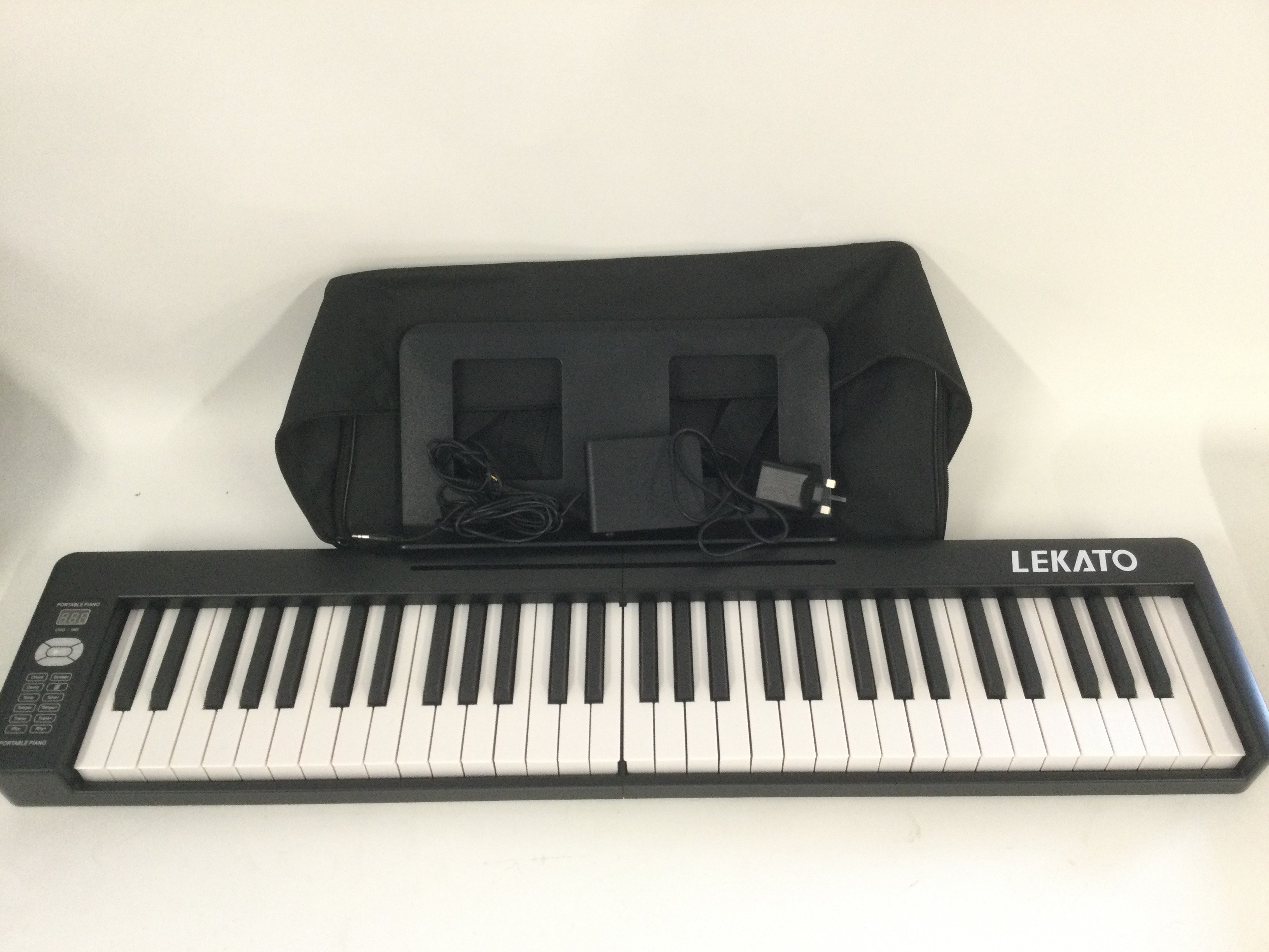 A Lekato folding keyboard with original case and accessories and folding stool (2).