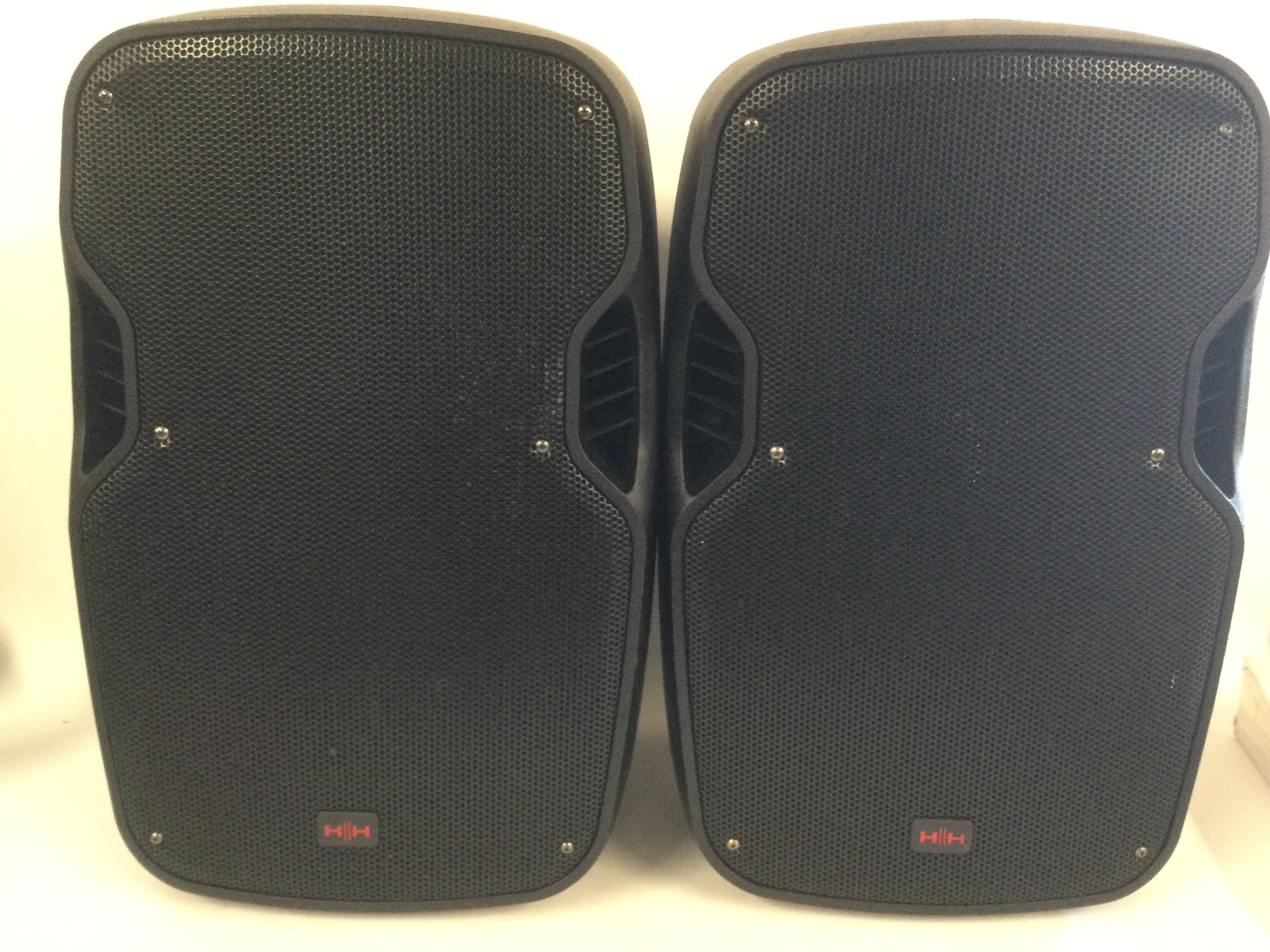 A pair of HH HPX-112 PA speakers and stands plus a box of leads.