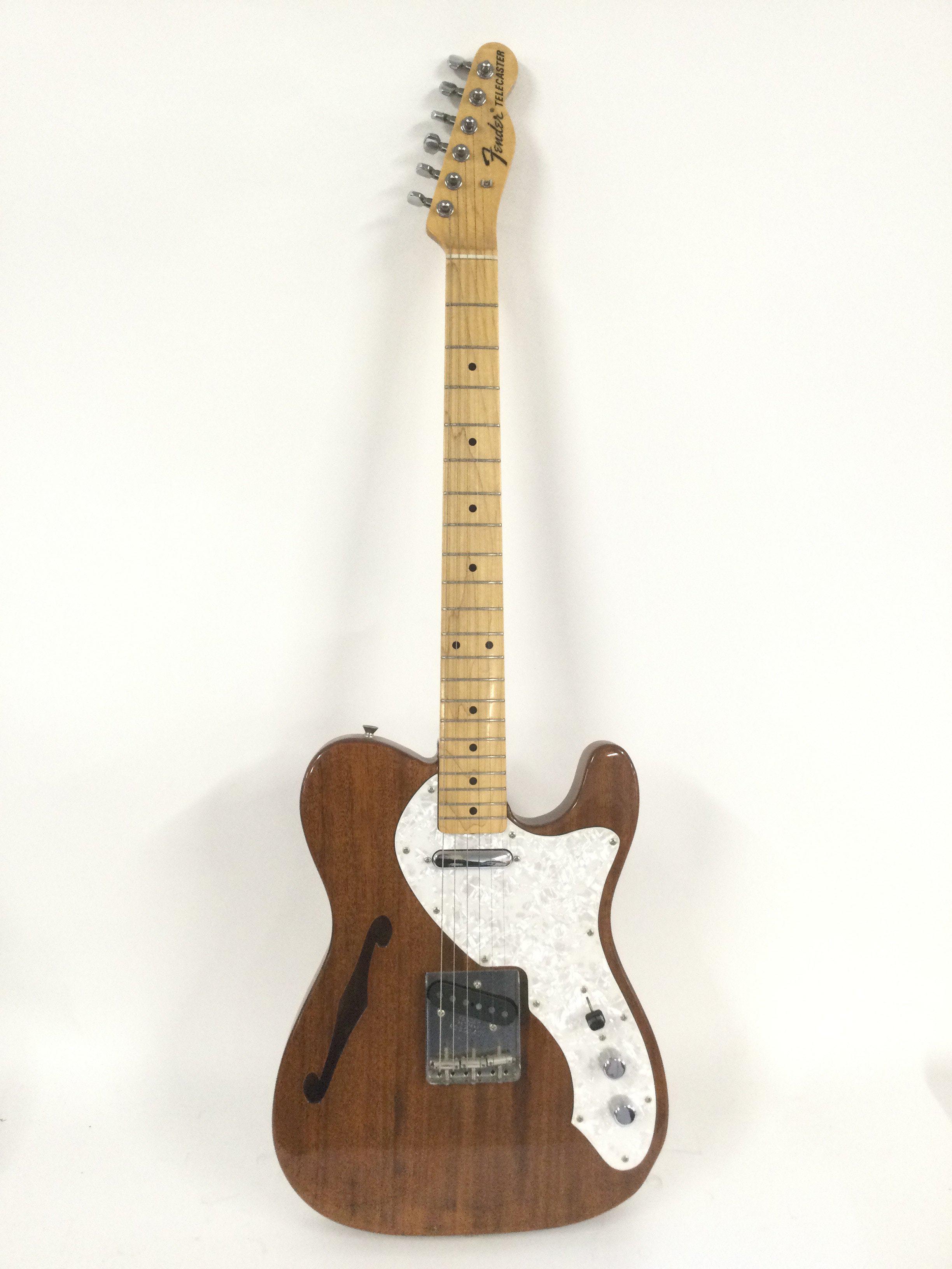 A Japanese Fender Telecaster Thinline electric guitar with hard carry case.