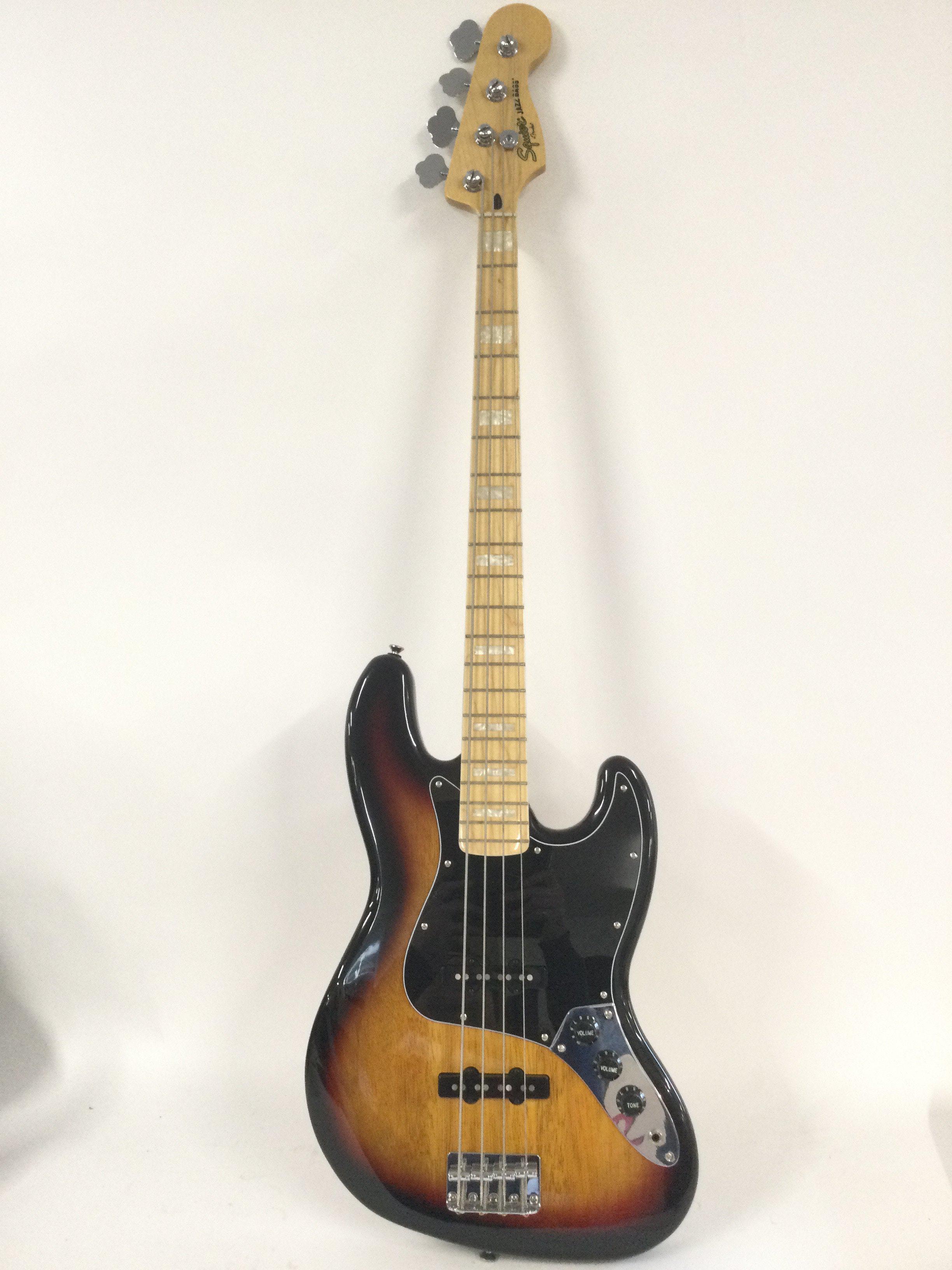 A Fender Squier jazz bass guitar. Comes with a soft carry case.