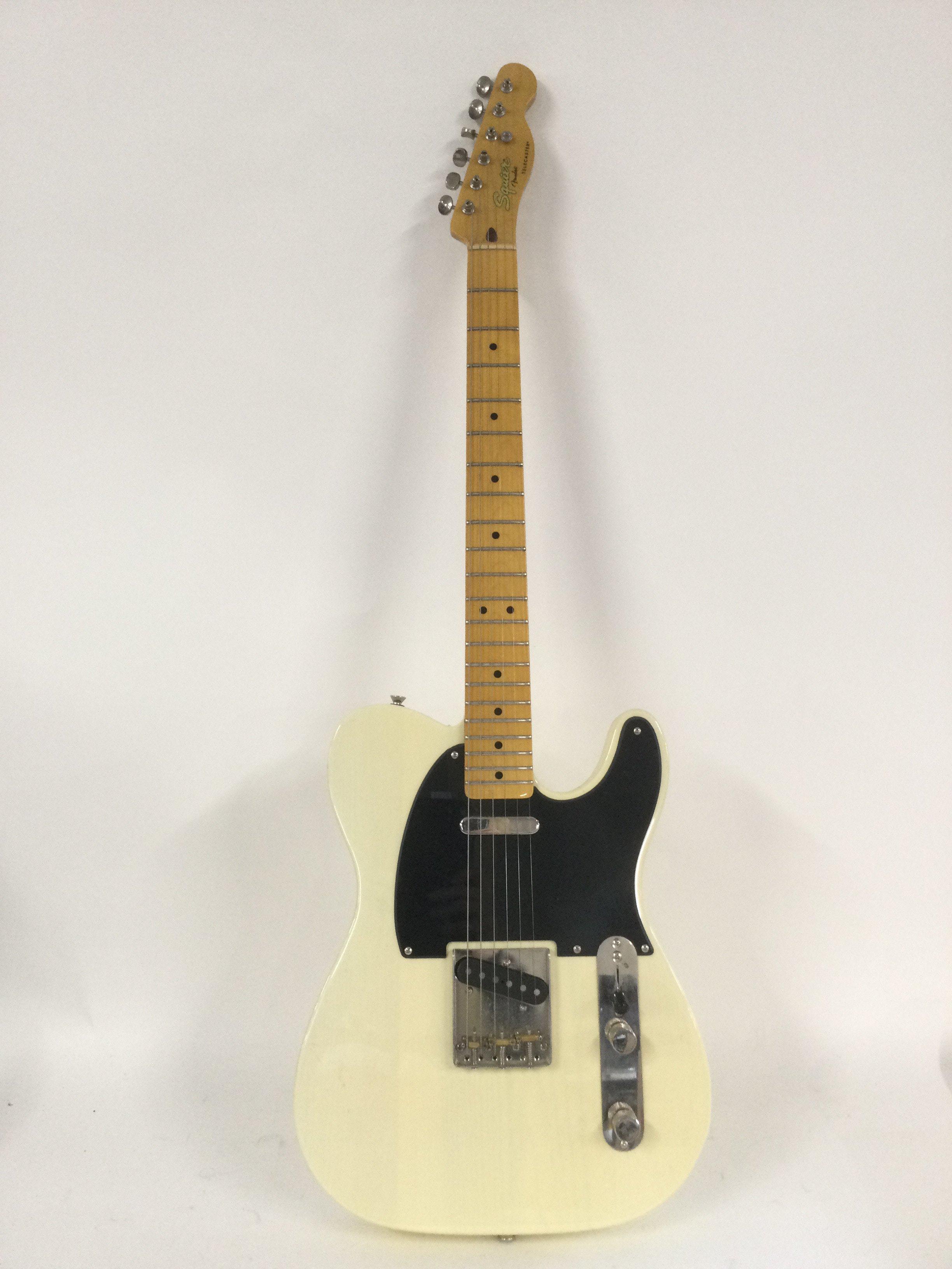 A Fender Squier Telecaster in a cream finish with a black pickguard. Comes with a soft carry case.