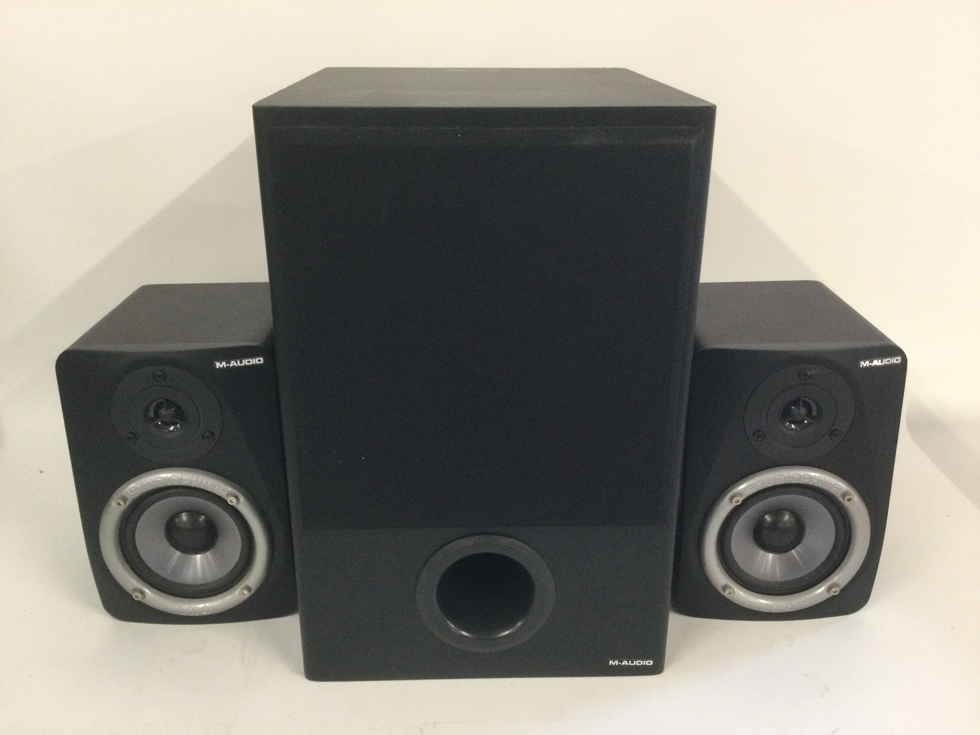 A boxed M-Audio Studiophile LX4 2.1 reference monitor speaker system.