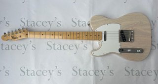 A 2004 Fender Japan Left Handed Telecaster electric guitar in excellent unplayed condition. This guitar comes with a maple neck and is finished in translucent US Blonde (Paint reference 67) which is a Fender Japan only finish. It comes with Fender Noiseless Pickups and all original parts. In near-mint condition with no real evidence of significant play-wear. No visible markings g or damage of any kind or tarnishing to brightwork. Comes with non original tweed case