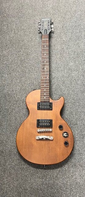 An Epiphone Vintage Edition in walnut finish. Brand new still in packaging. Only taken out of original packaging for catalogue photograph and salesroom display.