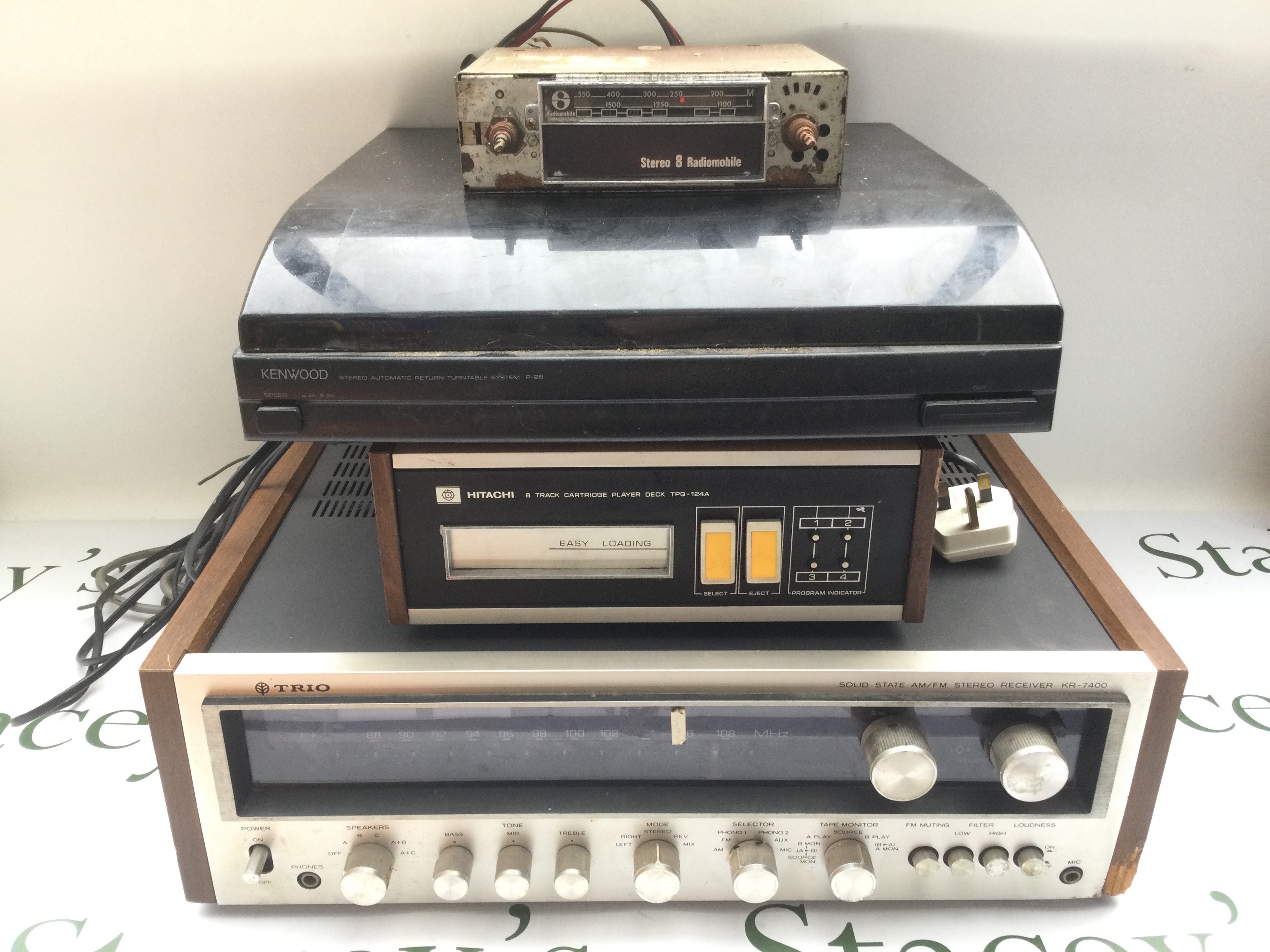 An assortment of vintage HiFi including a Hitachi 8 track player with cartridges, an in car 8 track player with speakers, a Trio KR-7400 stereo receiver, Kenwood turntable plus some LPs, EPs and 7" singles by various artists.