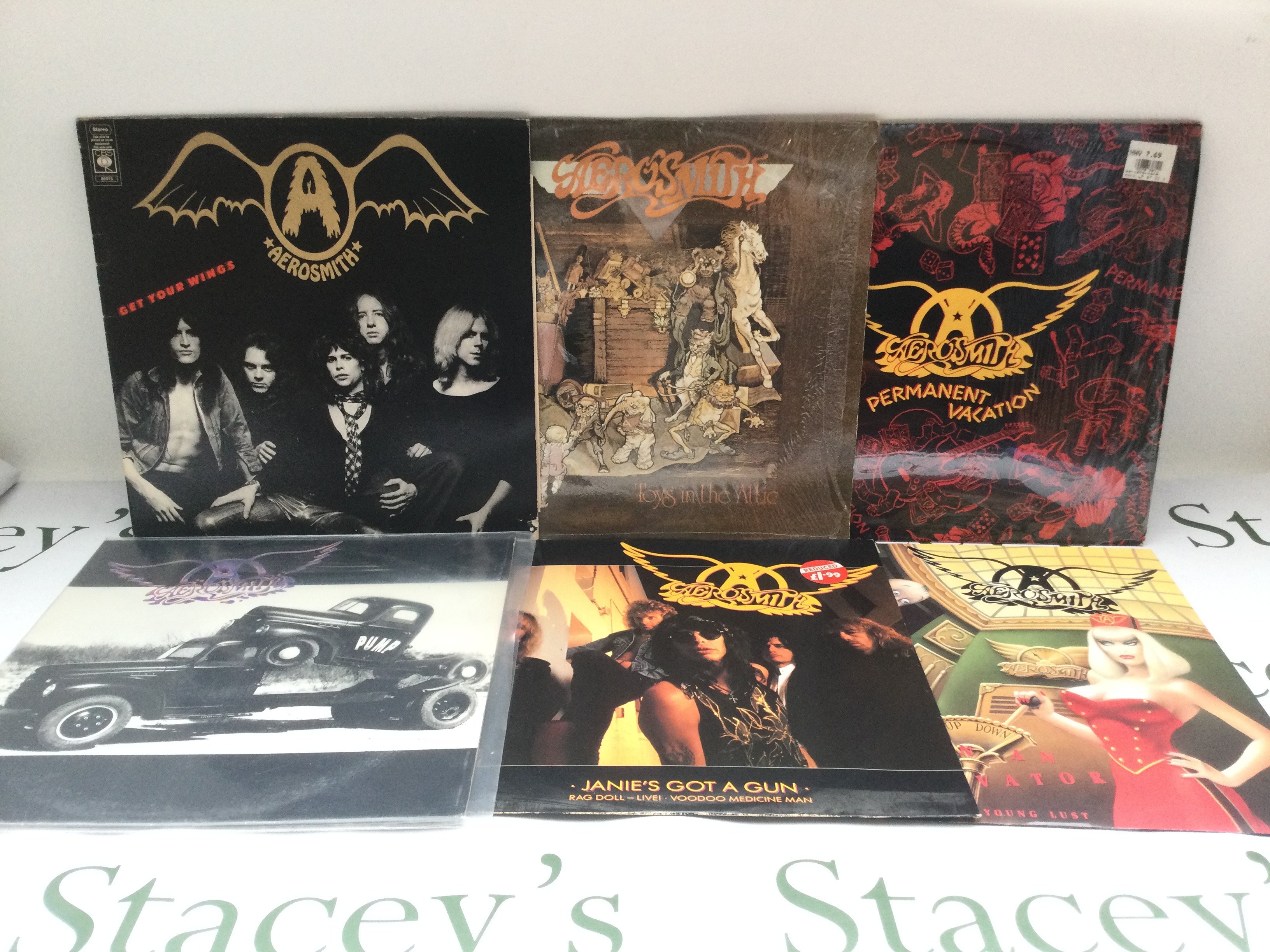 Four Aerosmith LPs and two 12" singles including 'Toys In The Attic', 'Pump' and others.