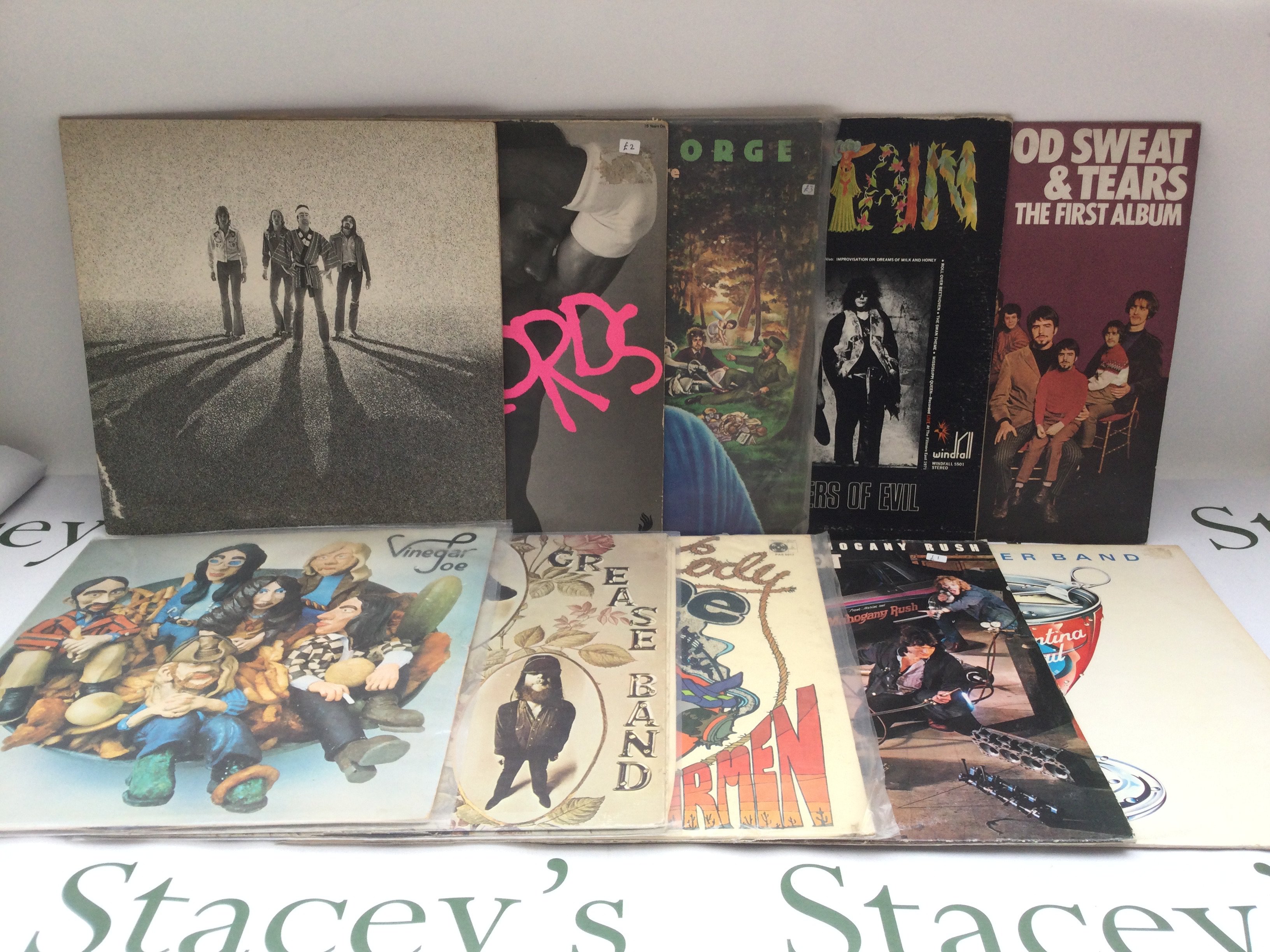 A record case of rock and pop LPs by various artists including Bad Company, Little River Band, Mountain and others.