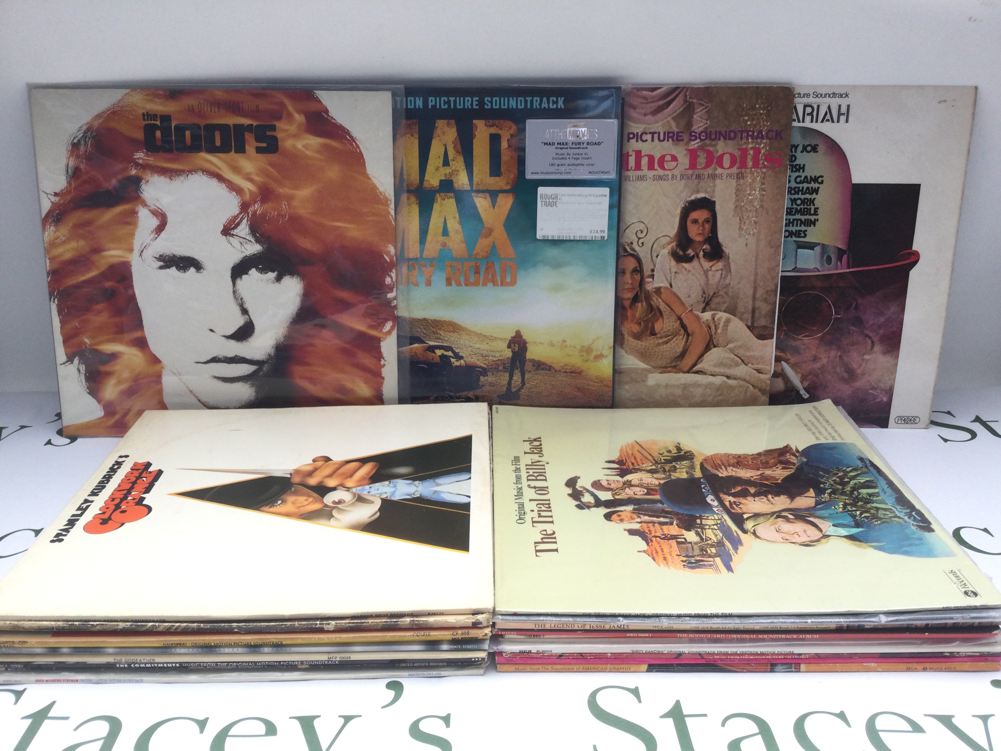 Two bags of movie soundtrack LPs including a 180g pressing of 'Mad Max - Fury Road', 'The Doors', 'American Graffiti' and others plus a Thirty Nine Steps laser disc.