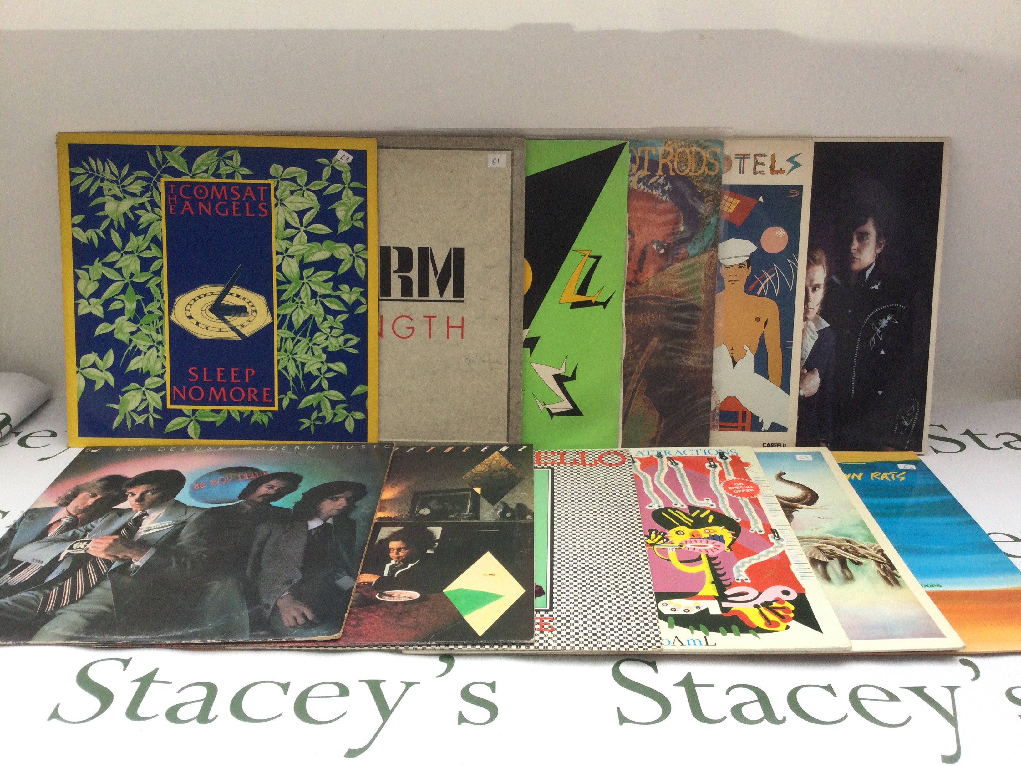 Two bags containing 23 new wave, rock and pop LPs by various artists including Elvis Costello, Dr Feelgood, Nick Lowe and others. Includes a promo disc.