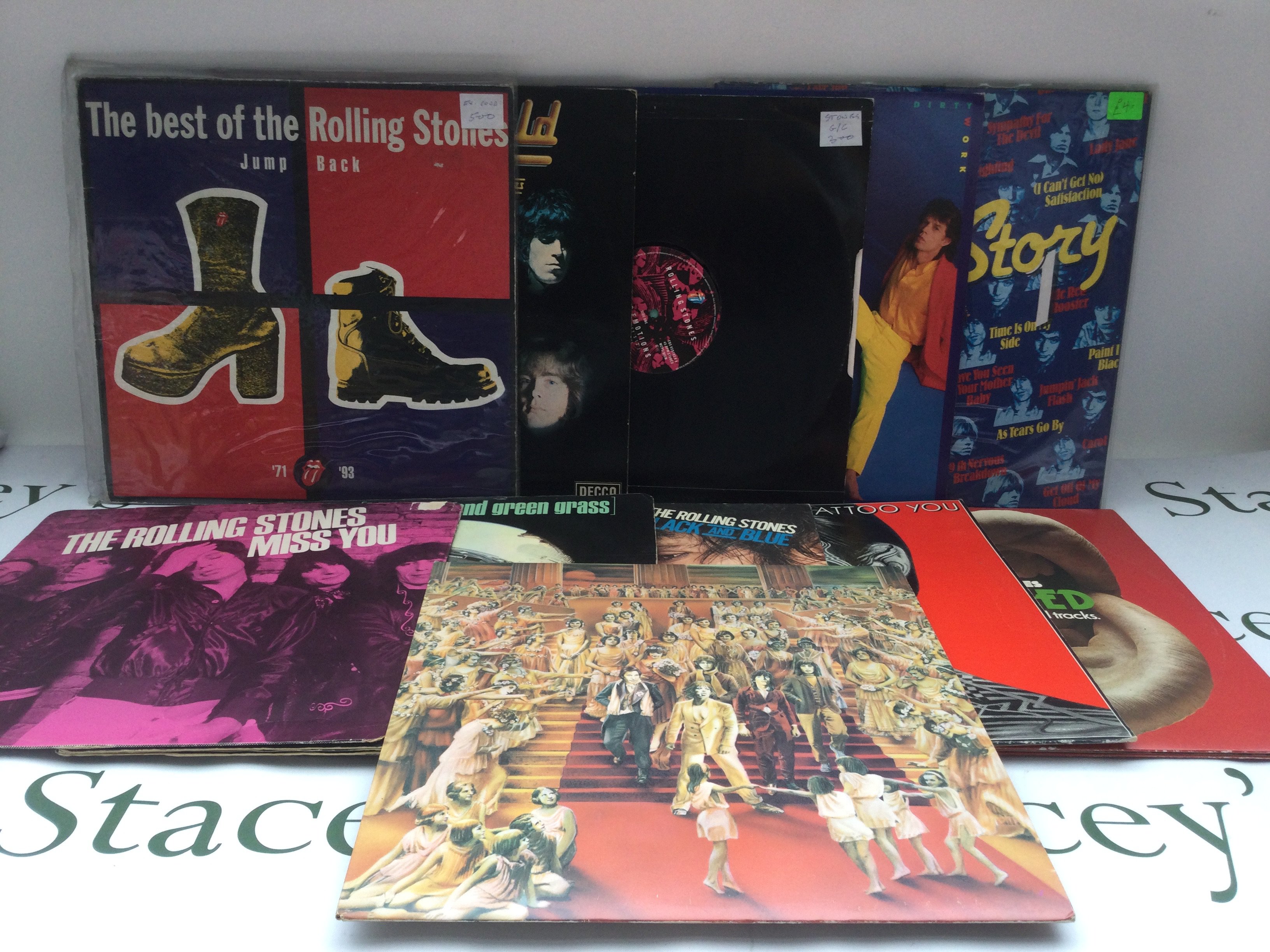 Two bags containing 20 Rolling Stones and solo LPs, EPs and a 10" disc comprising a lenticular sleeve 'Their Satanic Majesties Request', 'Some Girls', 'Primitive Cool' and others.