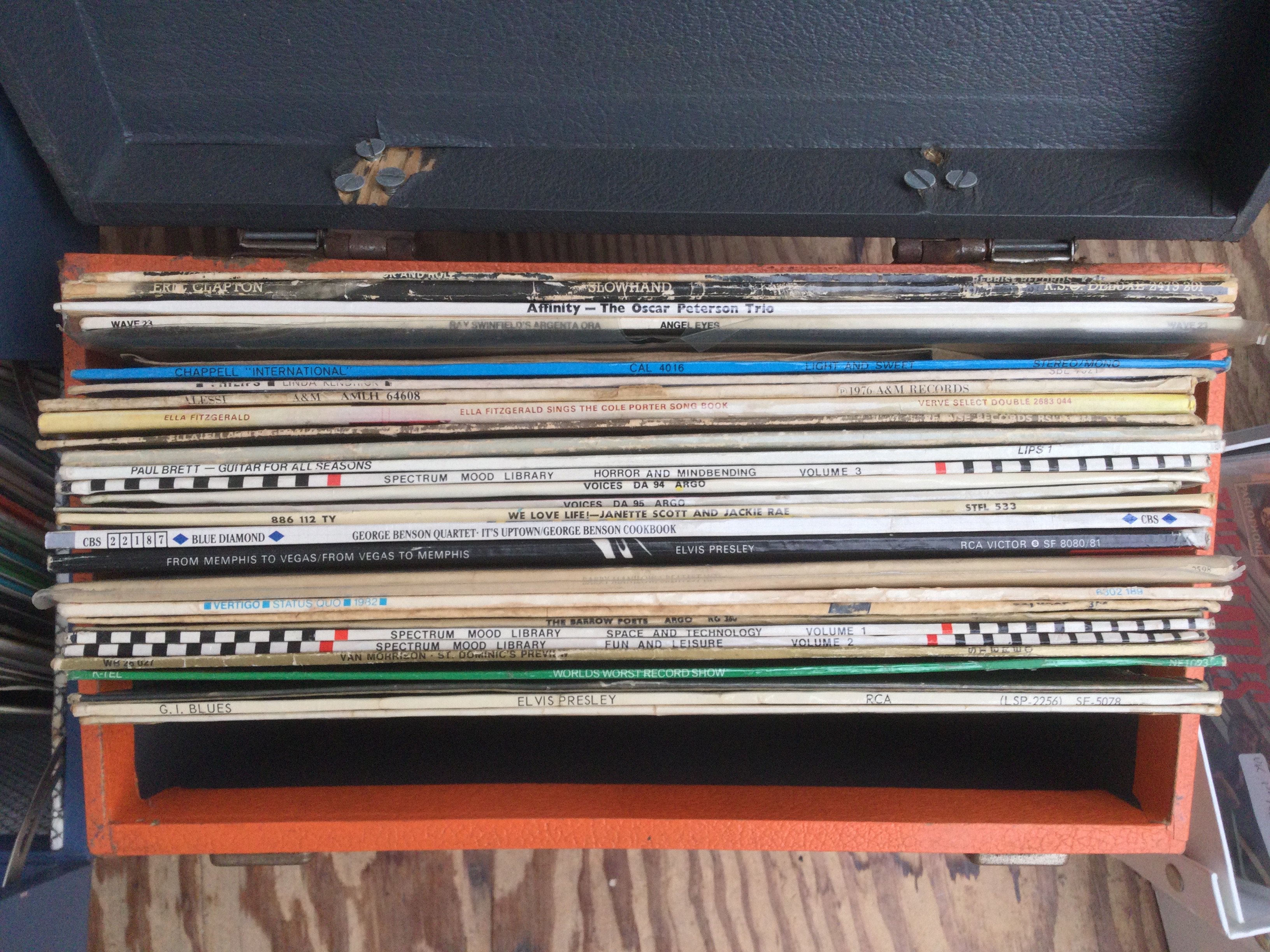 Two record cases of LPs by various artists including Elvis Presley, Oscar Peterson and others.