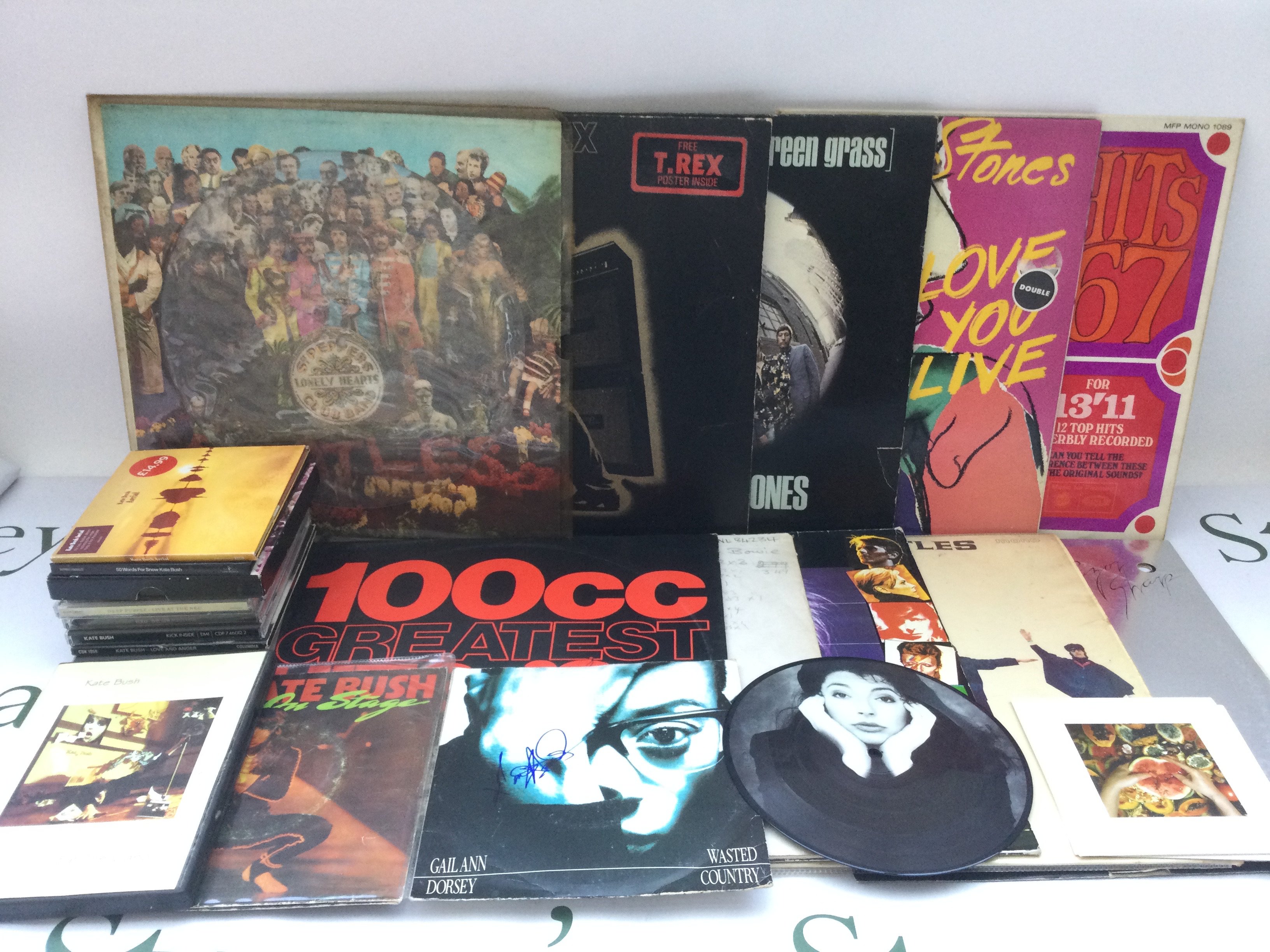 A collection of LPs and CDs by various artists including The Beatles, Kate Bush, David Bowie and others.