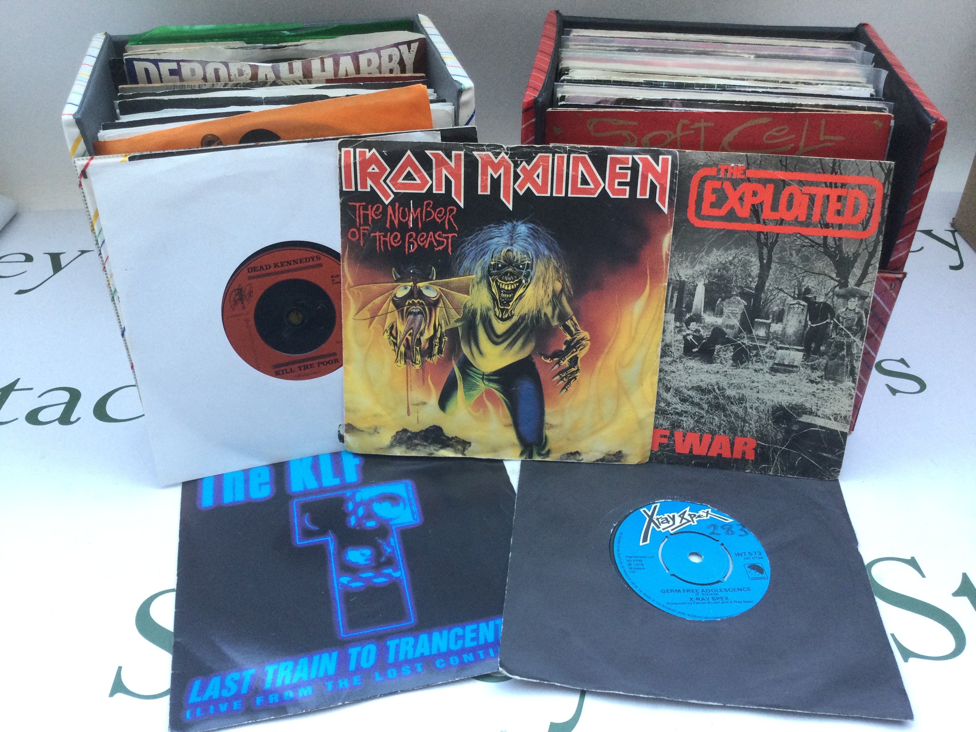 Four record cases by various artists including The Rolling Stones, Iron Maiden, Dead Kennedys, The Stone Roses and others.