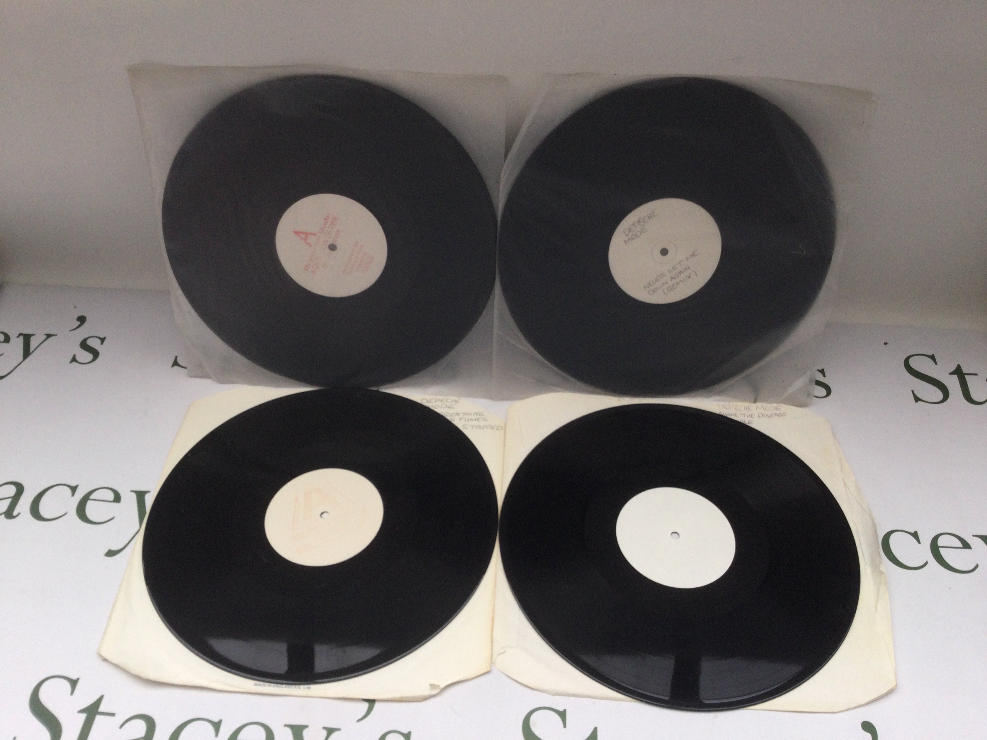 Four Depeche Mode 12" white label promo discs comprising 'Stripped', 'A Question Of Time', 'Never Let Me Down Again' and 'Shake The Disease'.