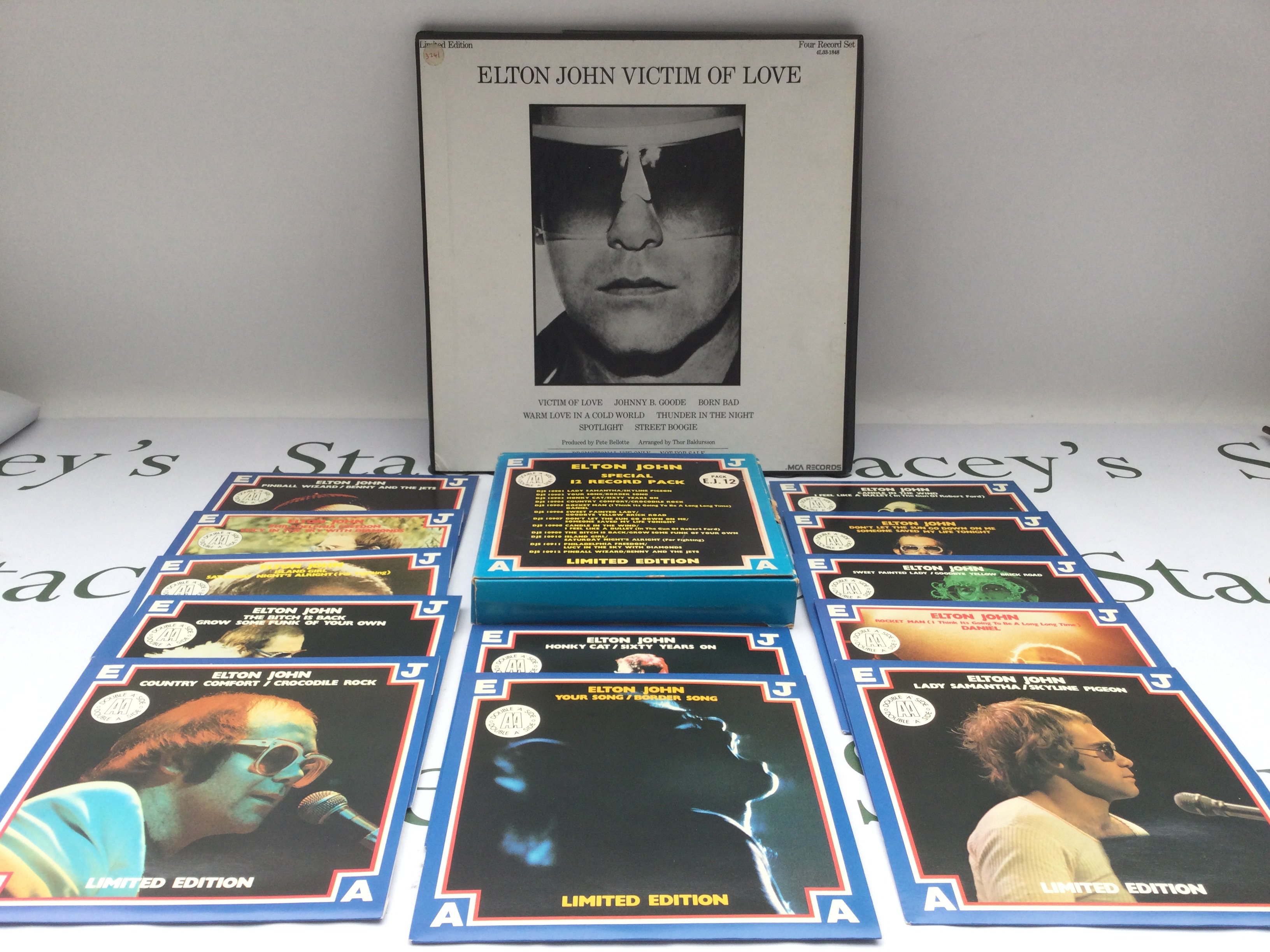An Elton John 'Victim Of Love' 4LP promo pack and a limited edition 7" singles pack (2).
