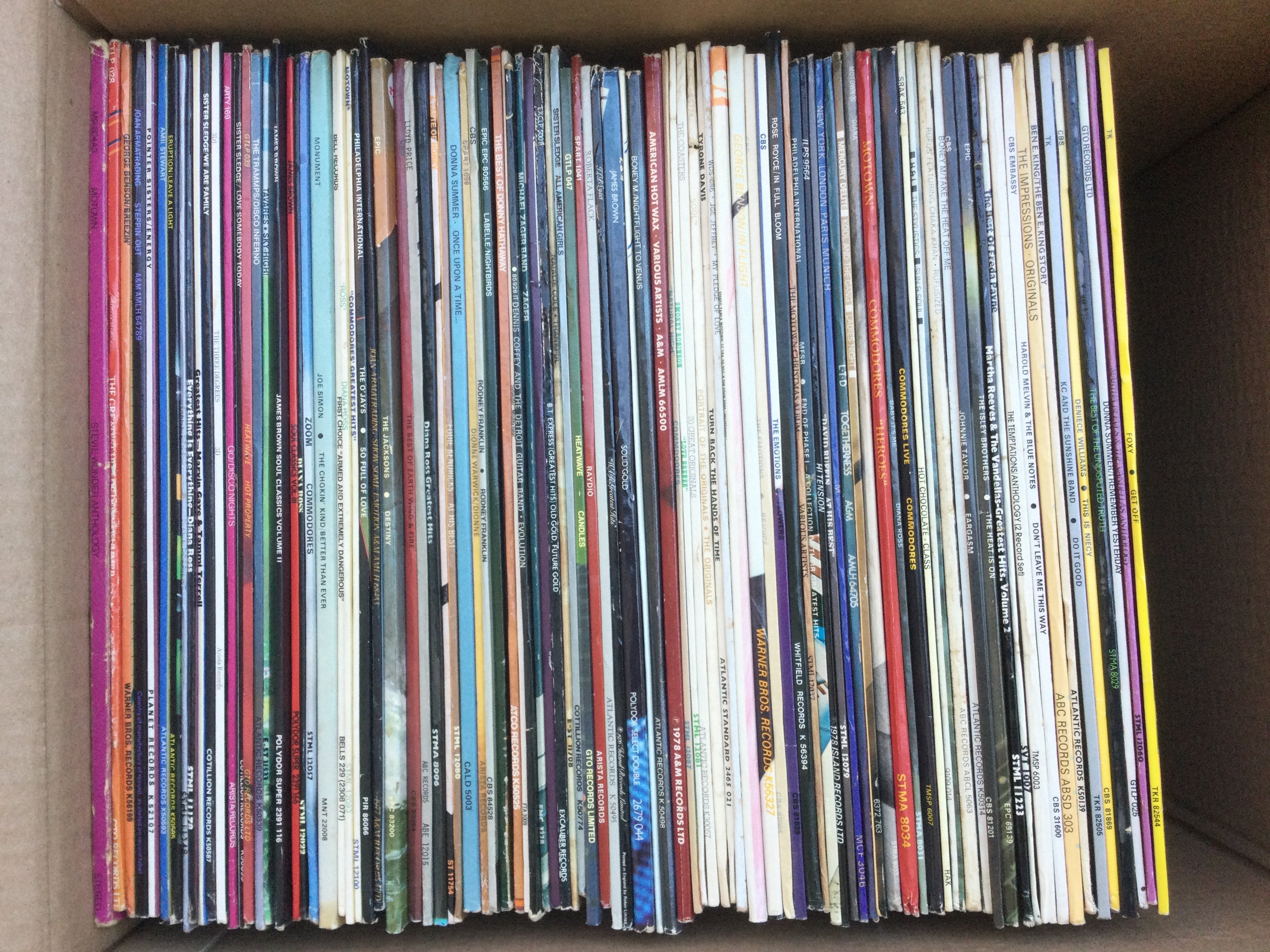 A box of soul and disco LPs and 12" singles by various artists including James Brown, Diana Ross, George Benson and others.