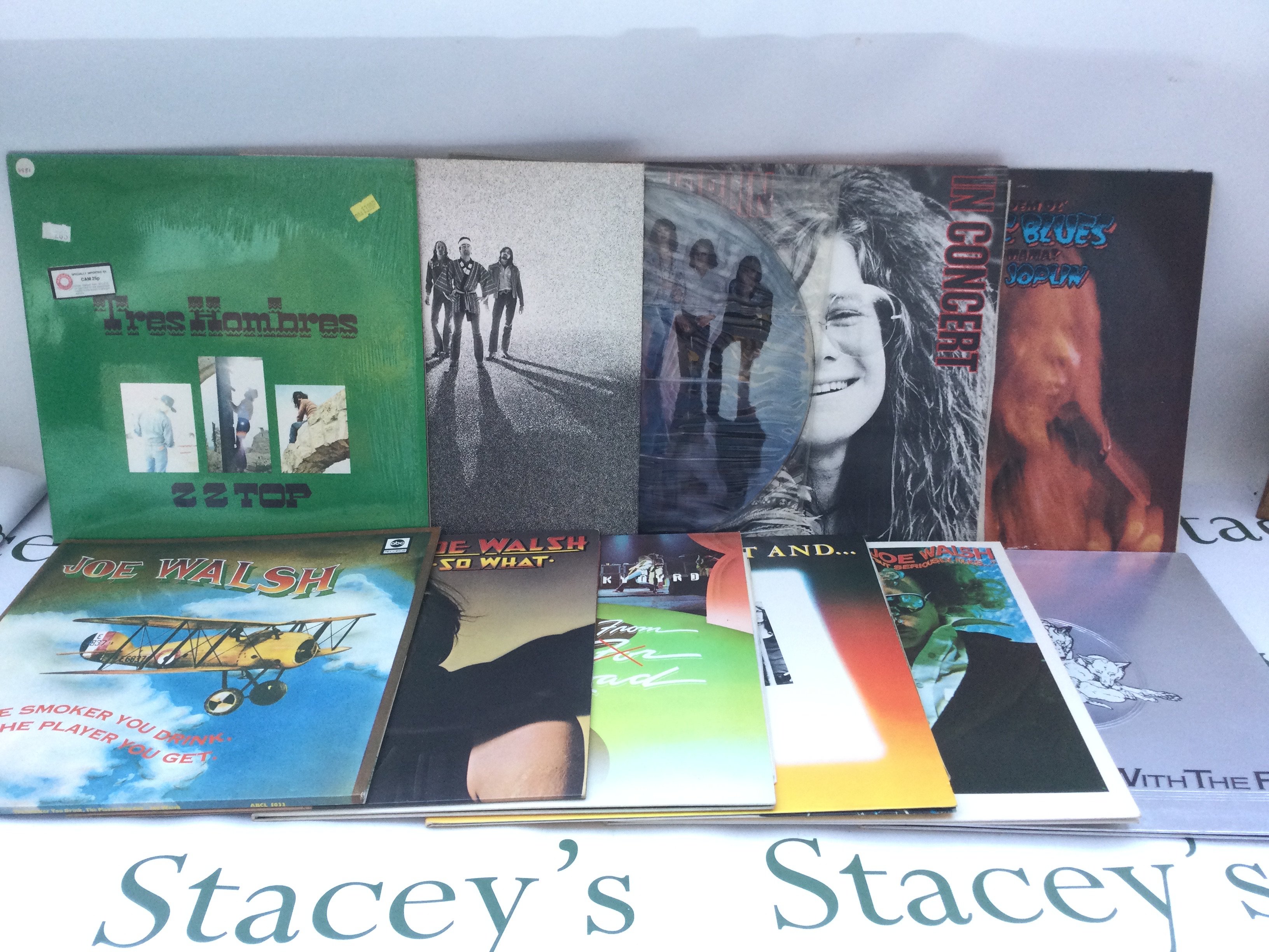 Two bags containing a collection of 23 rock LPs by various artists including Bad Company, Janis Joplin, ZZ Top and others.