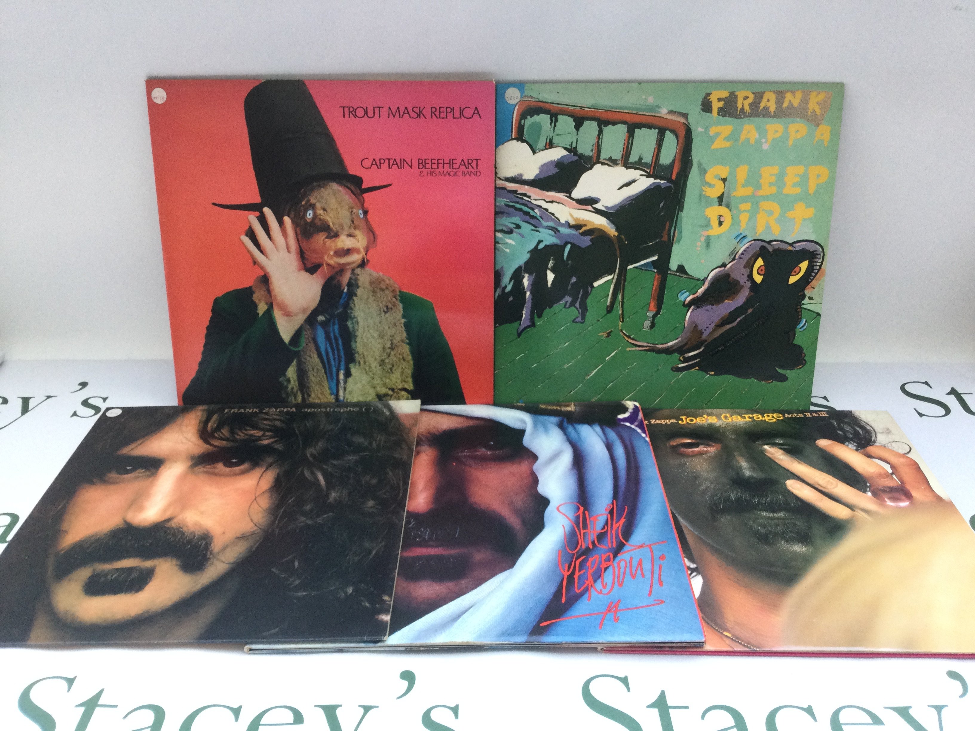 Four Frank Zappa LPs comprising 'Apostrophe', 'Sheik Yerbouti' and two others plus 'Trout Mask Replica' by Captain Beefheart (5). Includes two promo copies.