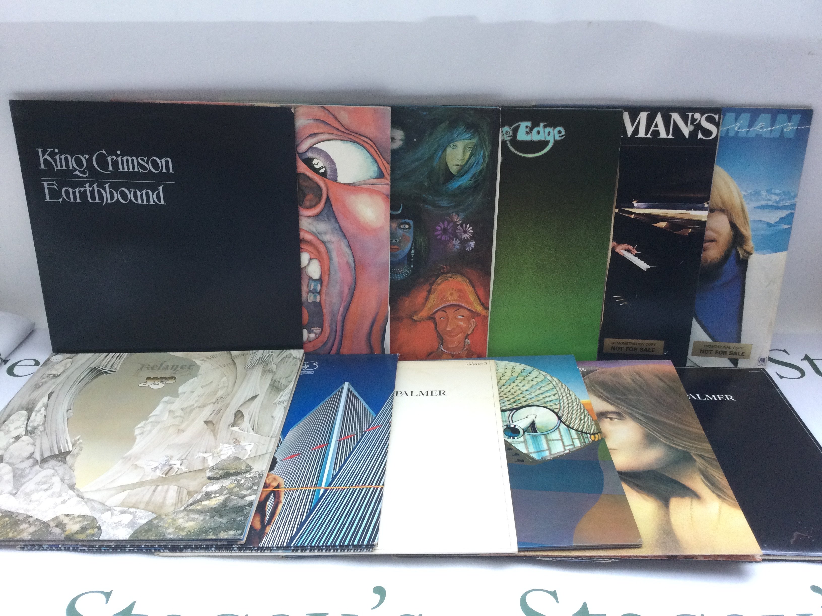 Twelve prog rock LPs by various artists including King Crimson, Yes, ELP and Rick Wakeman.