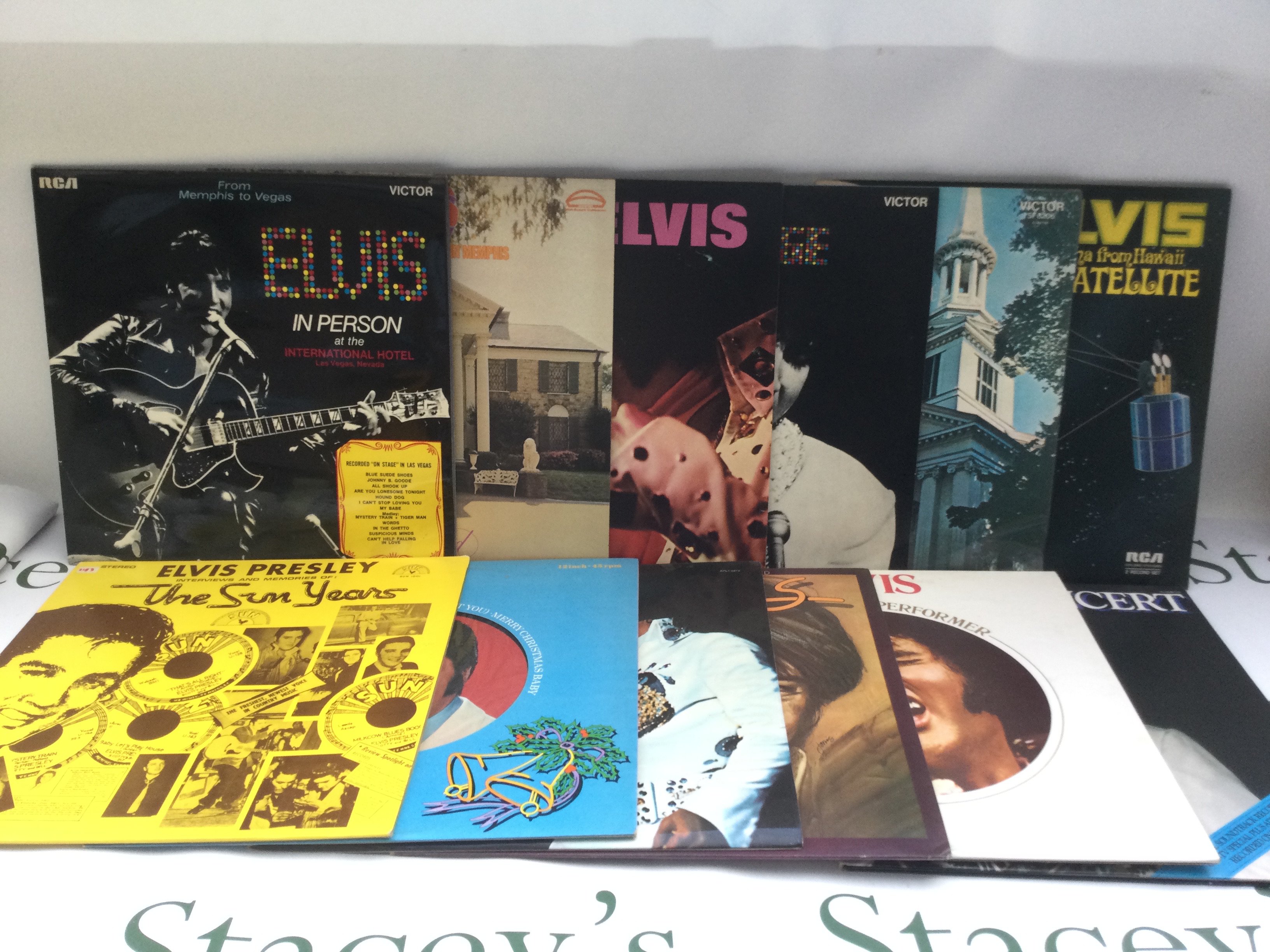 Two bags containing 23 Elvis Presley LPs including 'Moody Blue', 'Harem Holiday' and others. Includes two promo LPs.