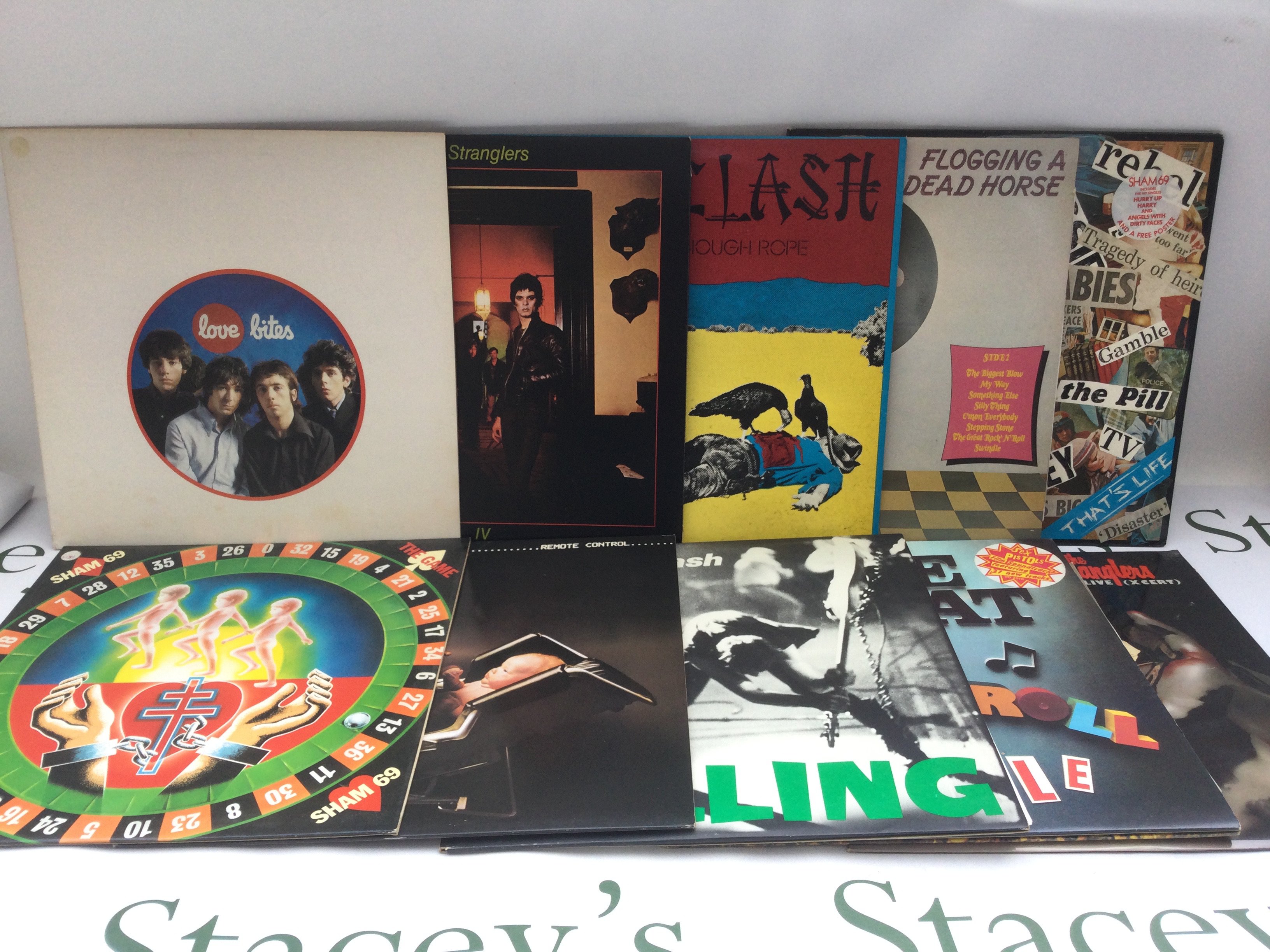 Two bags containing 21 punk rock LPs and 12" singles by various artists including Sex Pistols, The Clash, Buzzcocks and others. Includes two promo LP by The Tubes and The Dickies.