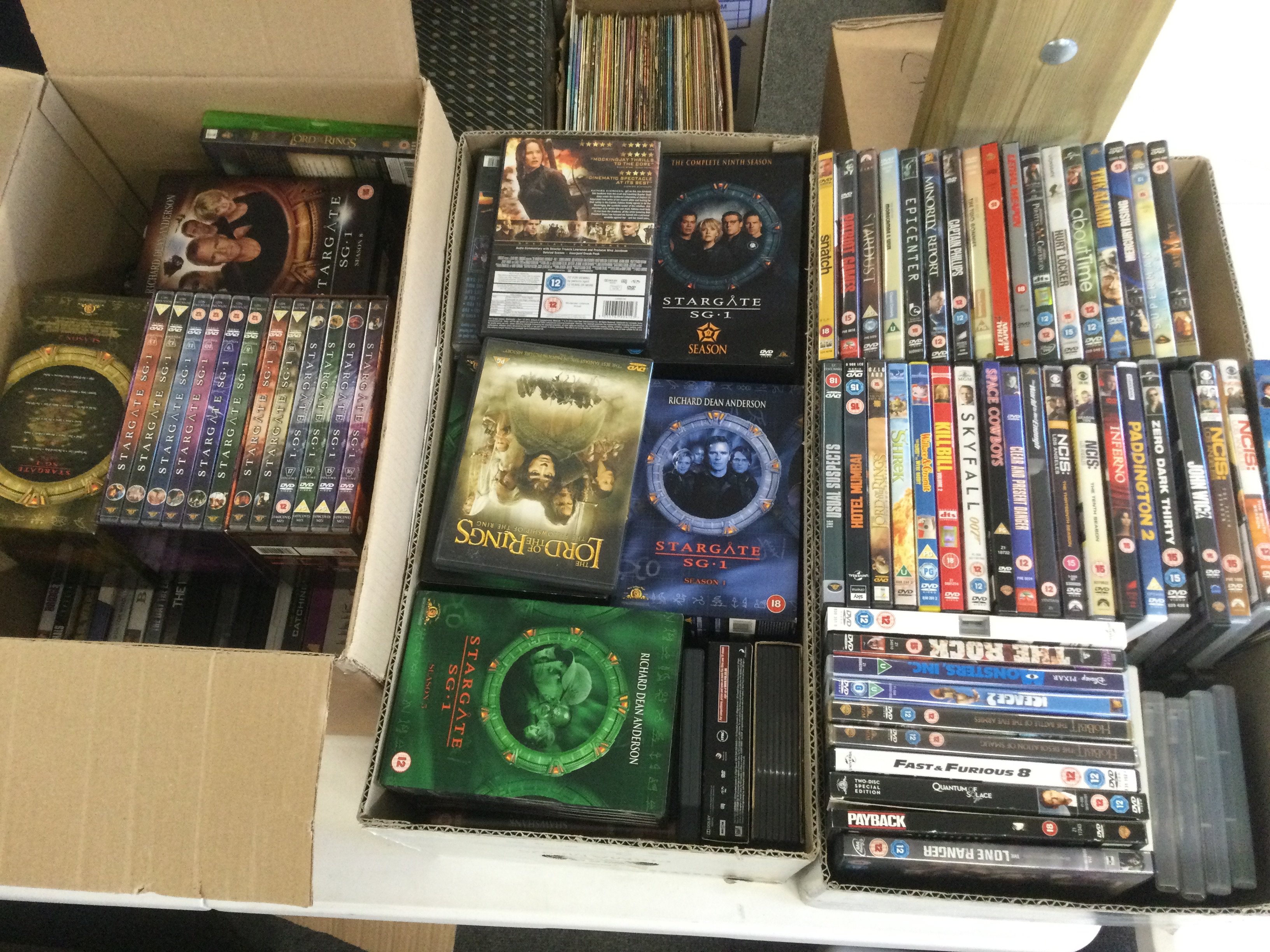 Three boxes of DVDs and BluRays.