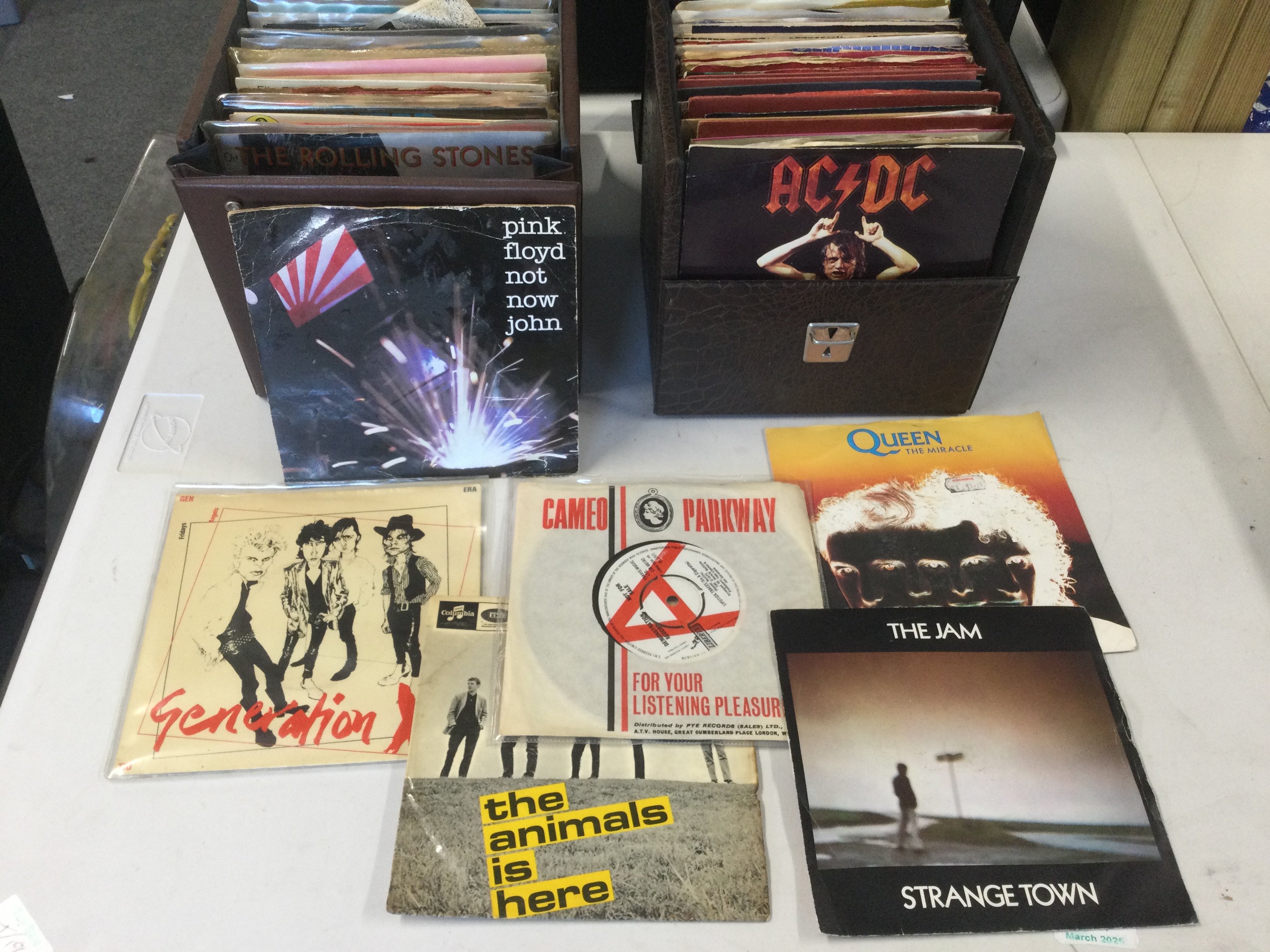 Ten record cases of 7" singles and EPs by various artists including Bob Marley, Sex Pistols, Patti Smith, Gene Vincent and many more.