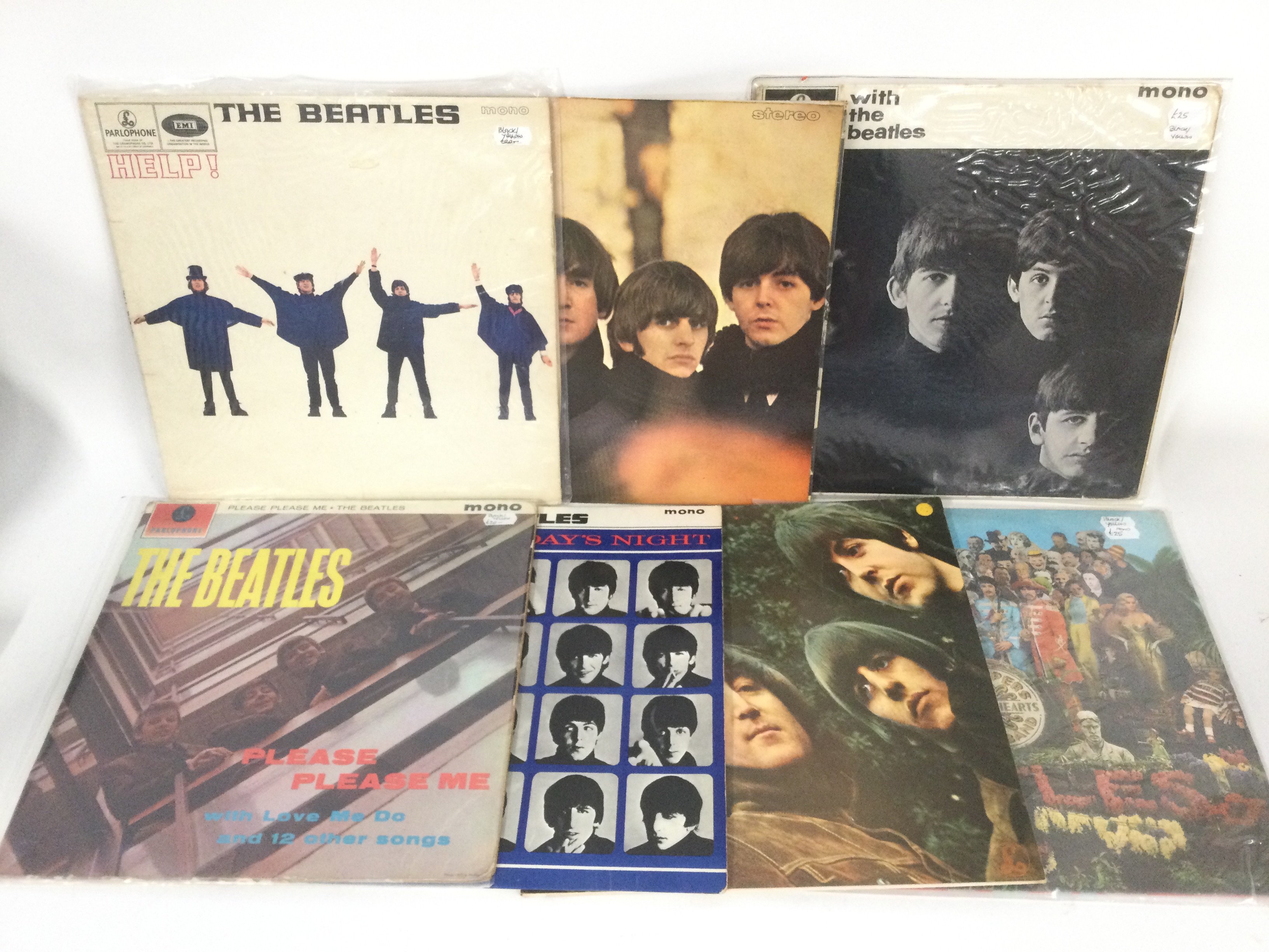 Fifteen Beatles LPs including 'Please Please Me' (black and yellow labels), 'Rubber Soul', 'Sgt Pepper' and others.