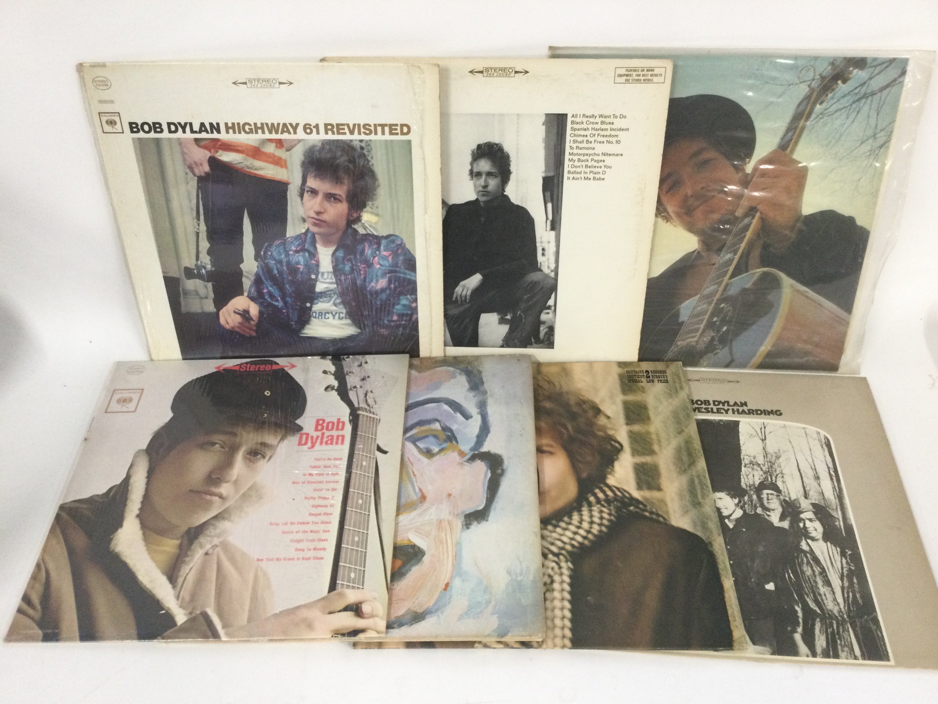Two bags containing 15 Bob Dylan LPs comprising 'Blonde On Blonde', 'Nashville Skyline', 'Highway 61 Revisited' and others