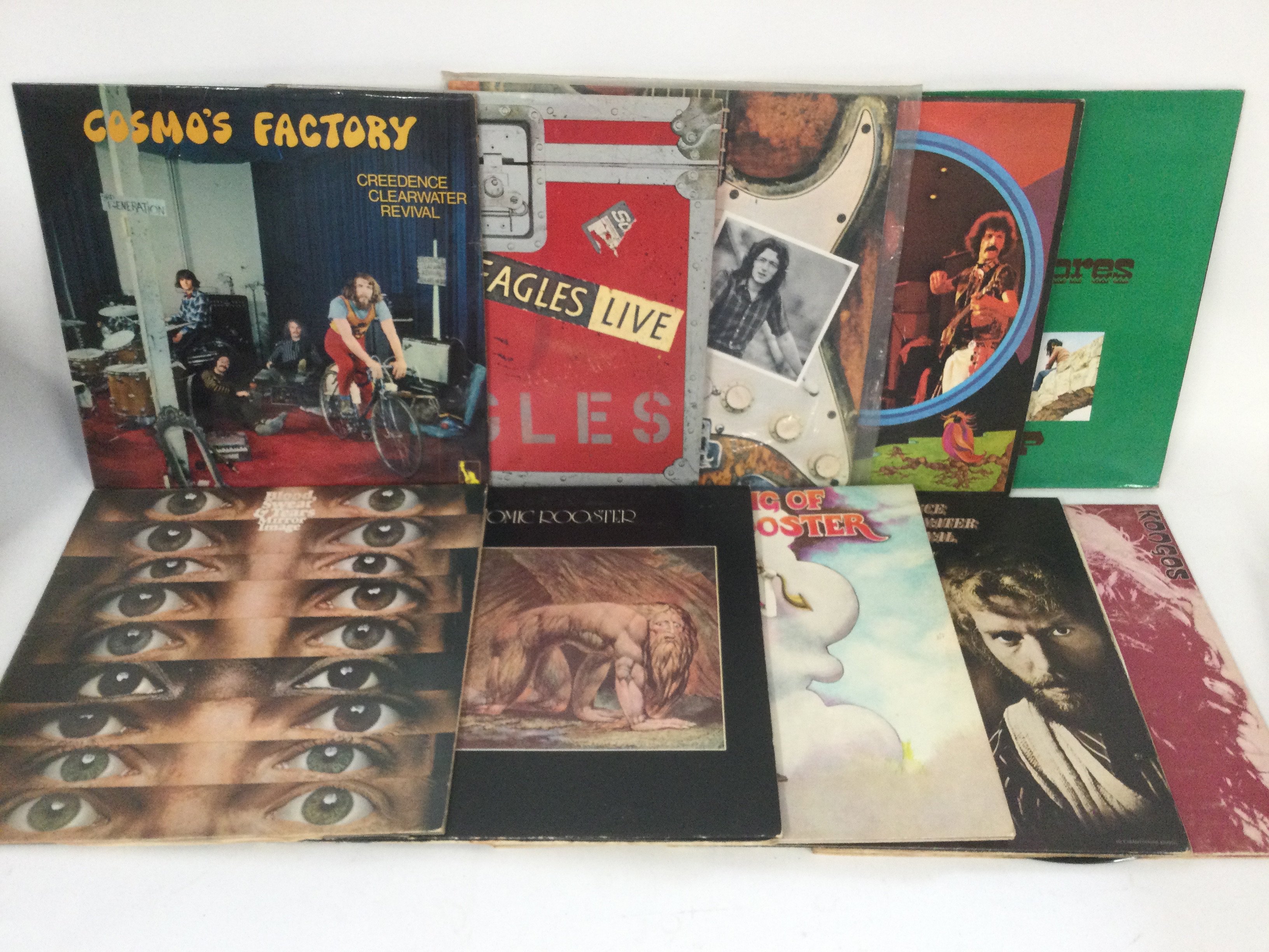 Two bags containing 20 rock and pop LPs by various artists including Atomic Rooster, Rory Gallagher, Creedence Clearwater Revival and others.