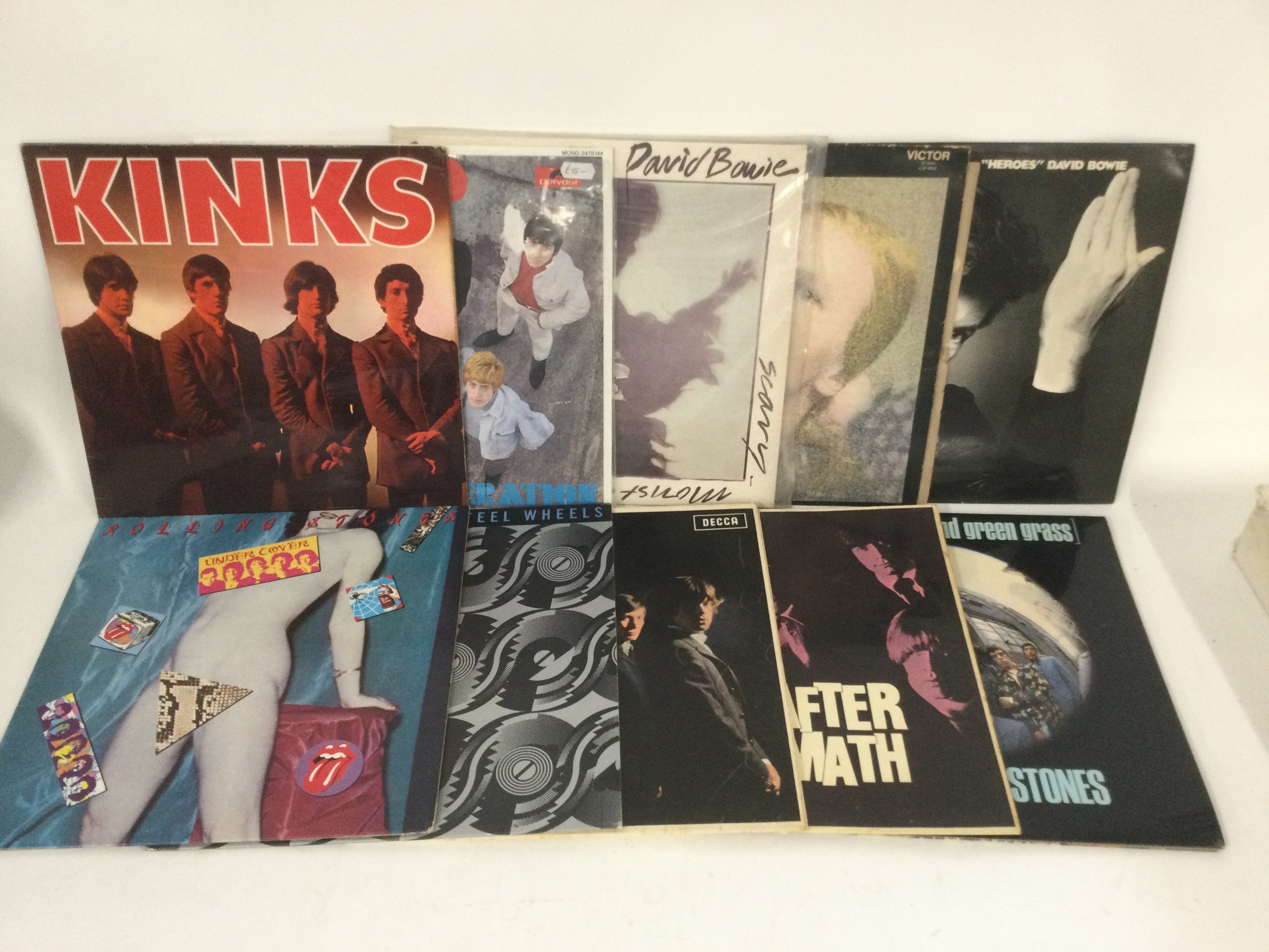 Two bags containing 20 rock LPs by various artists including David Bowie, The Rolling Stones, Queen and others. Includes a yellow vinyl 'Goodbye Yellow Brick Road'.