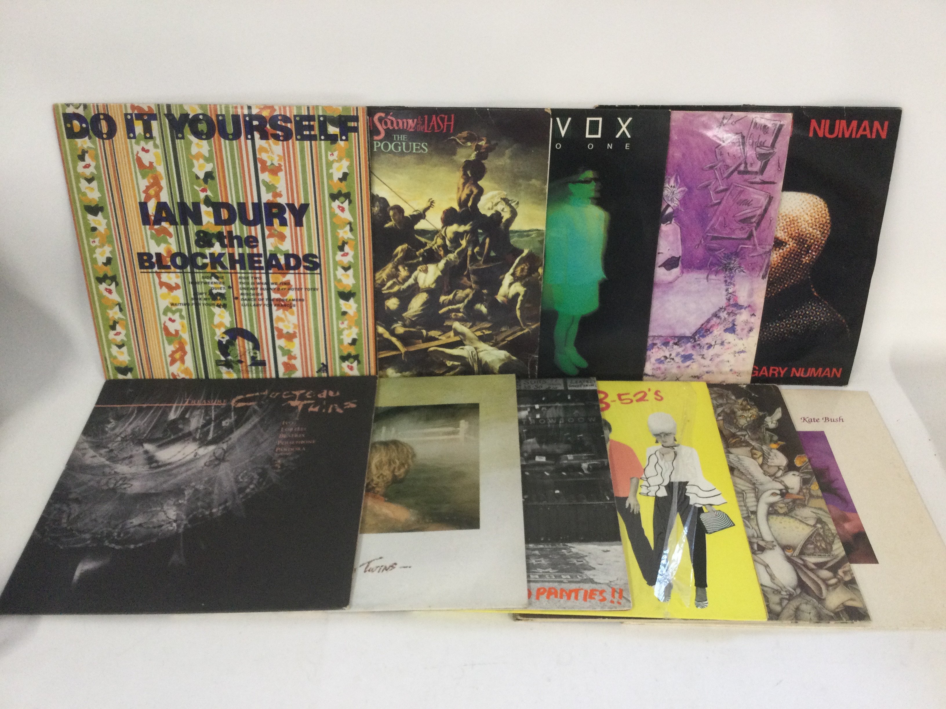 Two bags containing 22 post punk and new wave LPs LPs and 12" singles by various artists including The Pogues, Ian Dury, Cocteau Twins and others.